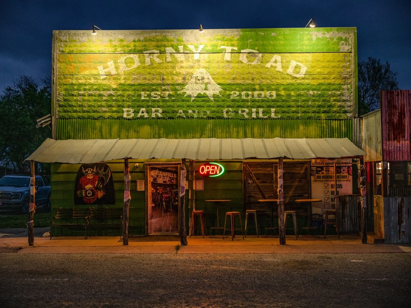 Original photograph of the Horny Toad bar & grill storefront at dusk
