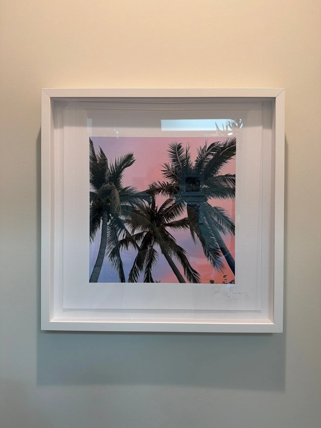 Framed photograph of three palm trees against a pink sky, framed print