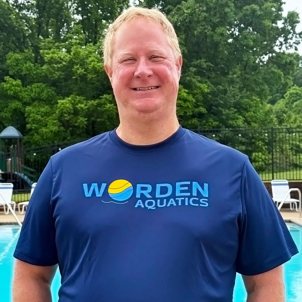 Coach Perry teaching private swim lessons, building confidence and swim skills in the pool.