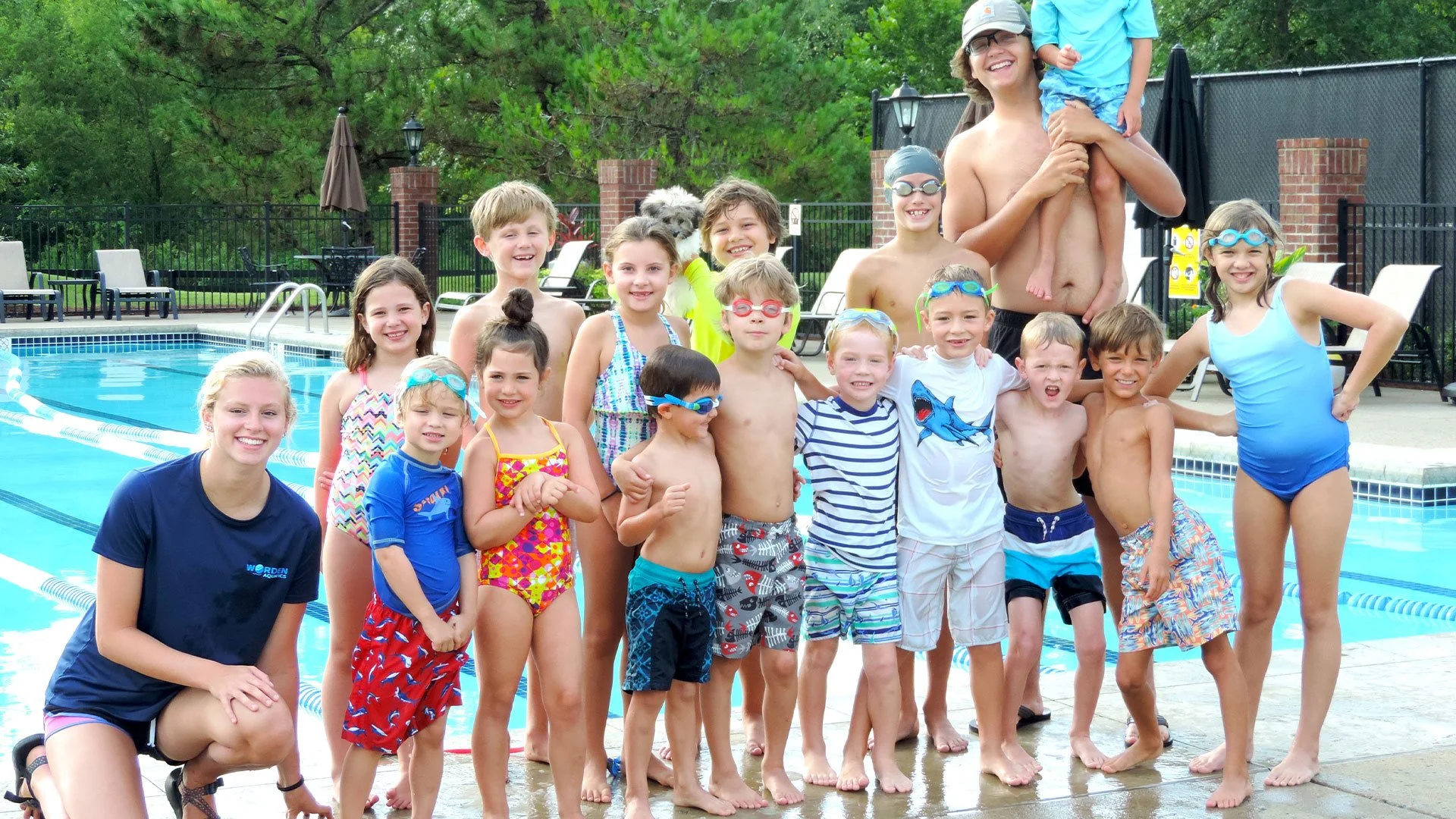 Non-competitive swim team practice at The Governors Club pool with kids swimming, playing games, and building skills