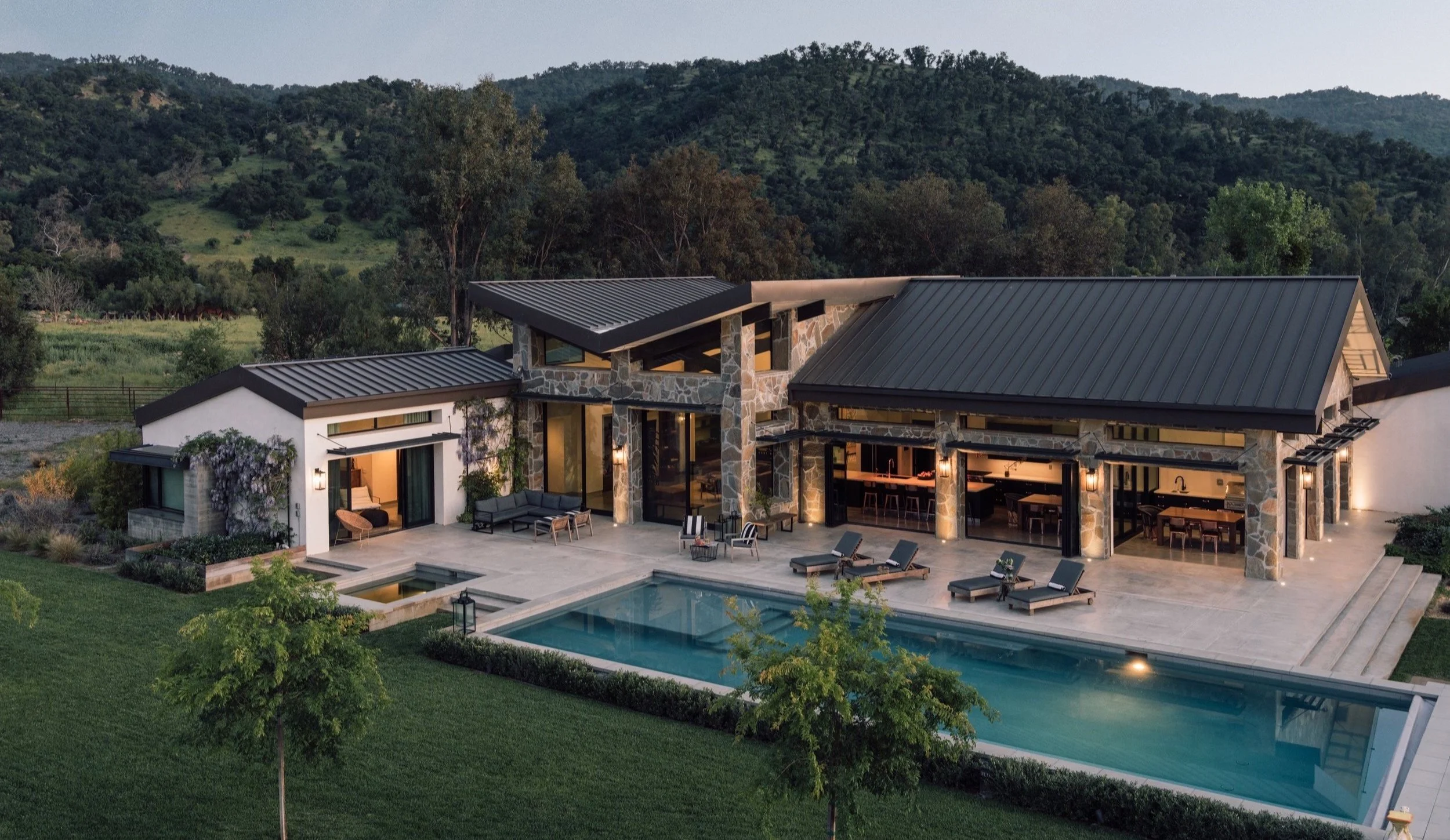 The private estate in Upper Ojai at dusk, with the pool and mountains behind
