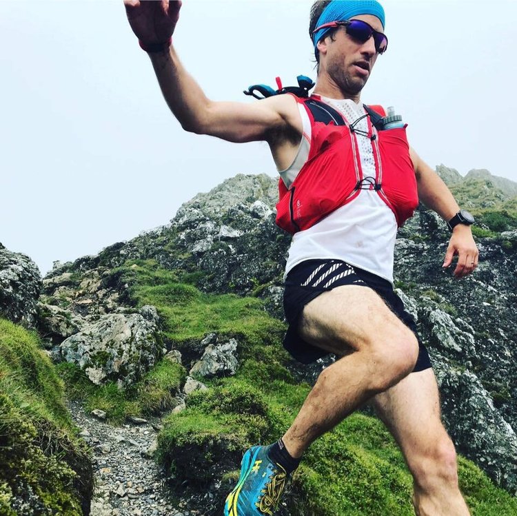Tim running a rocky mountain ridge