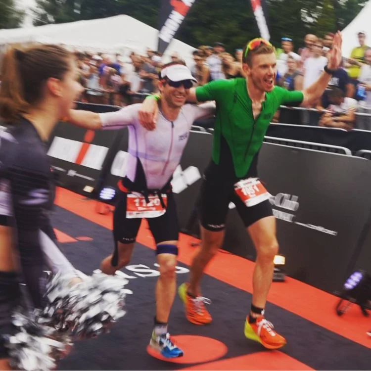 Tim celebrating at an Ironman finish line