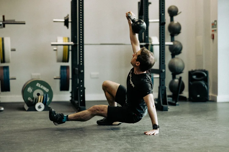 Tim doing strength training in the gym