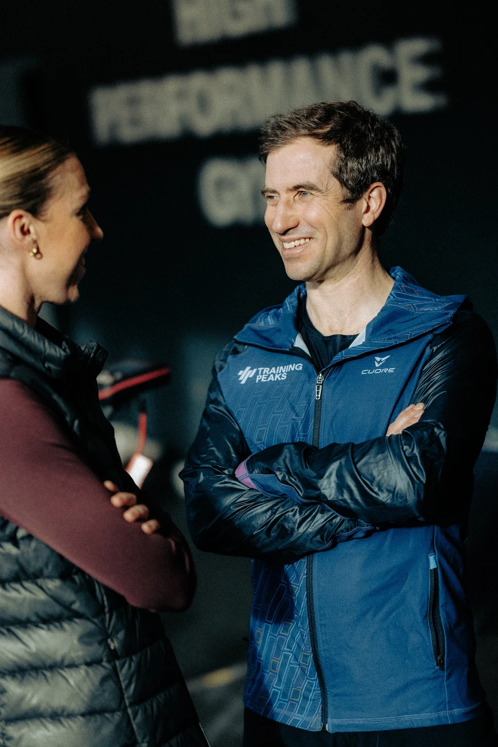 An HP3 coach talking with an athlete in the gym
