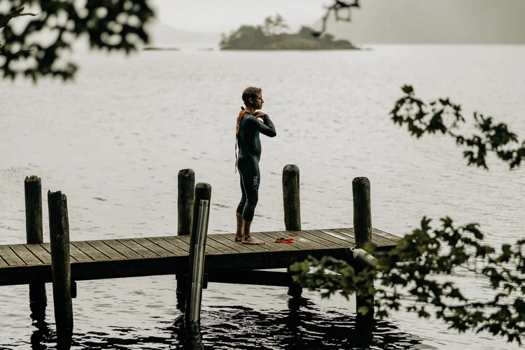 Tim standing on a lake jetty before an open water swim
