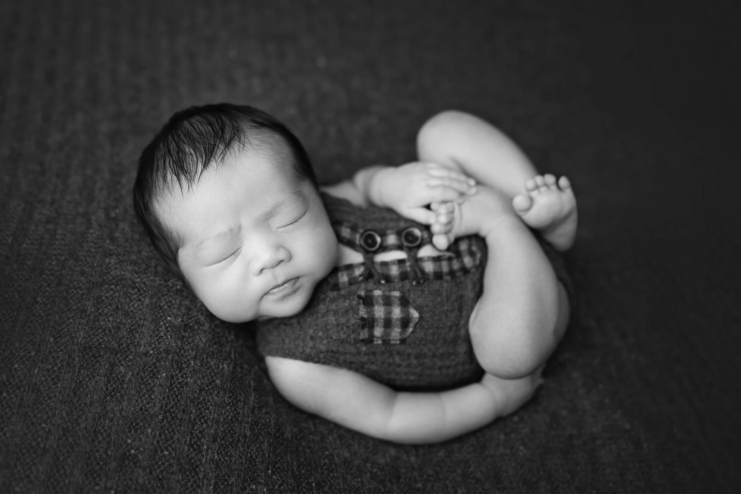 newborn baby boy in huck fin pose black and white austin texas photography studio