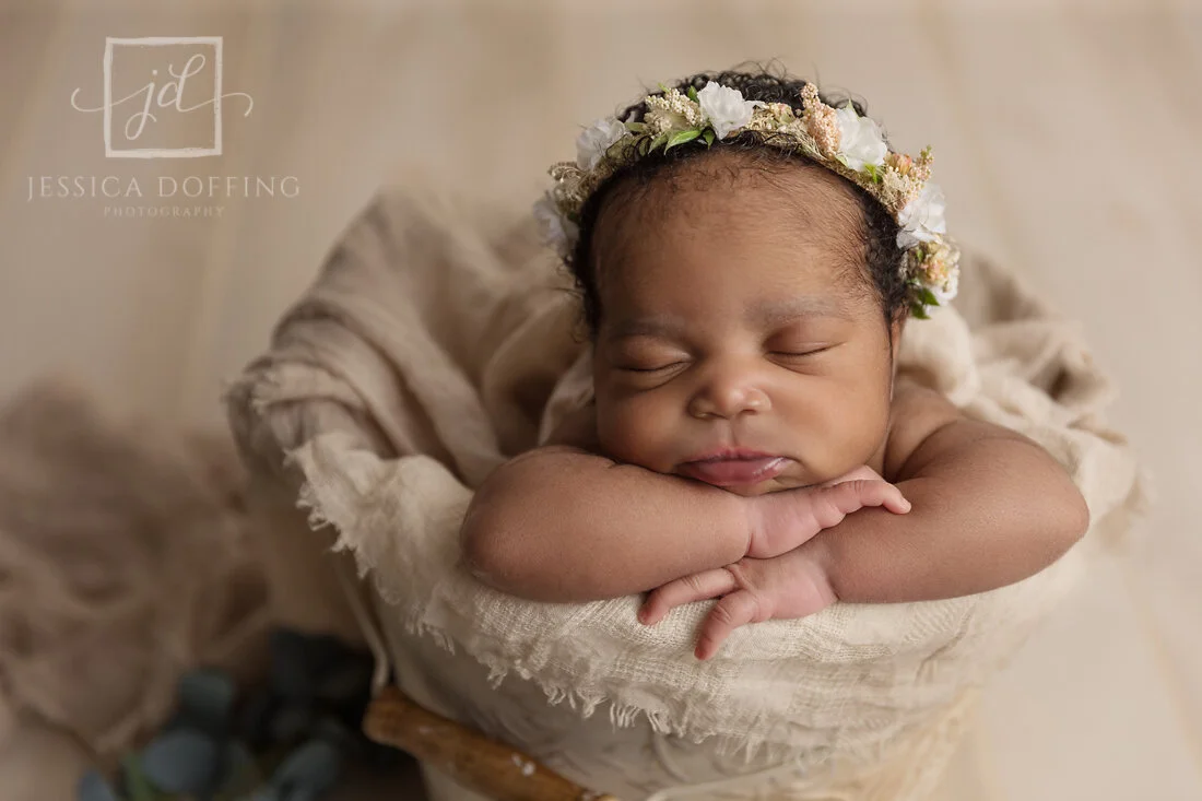 Baby Yasmine sleeping peacefully in a basket during her studio newborn photography session in Austin, Texas.