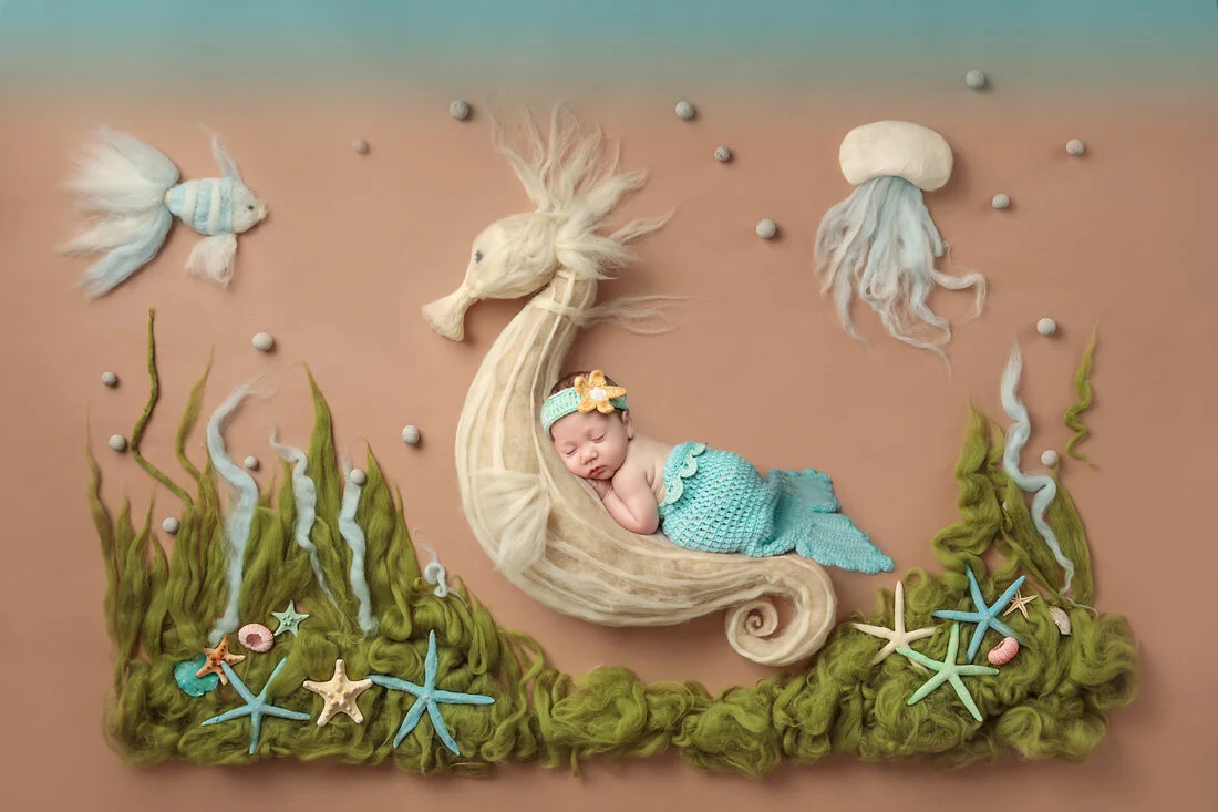 Newborn baby dressed as a mermaid in a whimsical underwater-themed setup during Baby Cassidy's Austin newborn photography session.