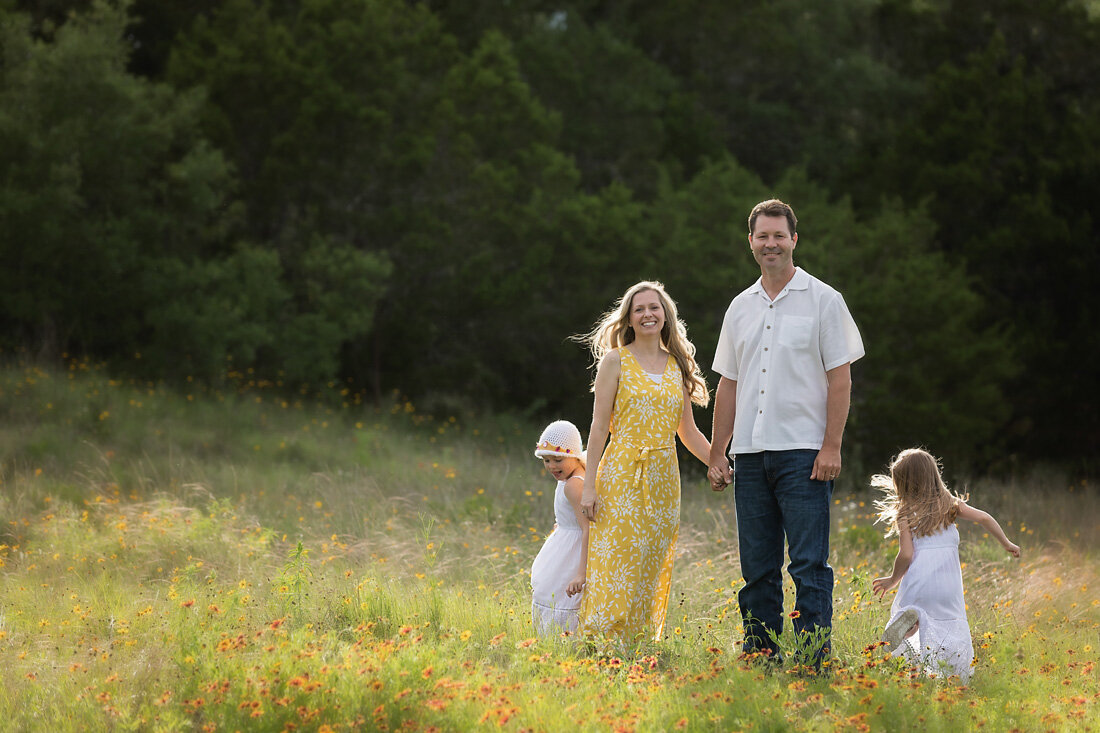 Parents and two girls in wildflowers