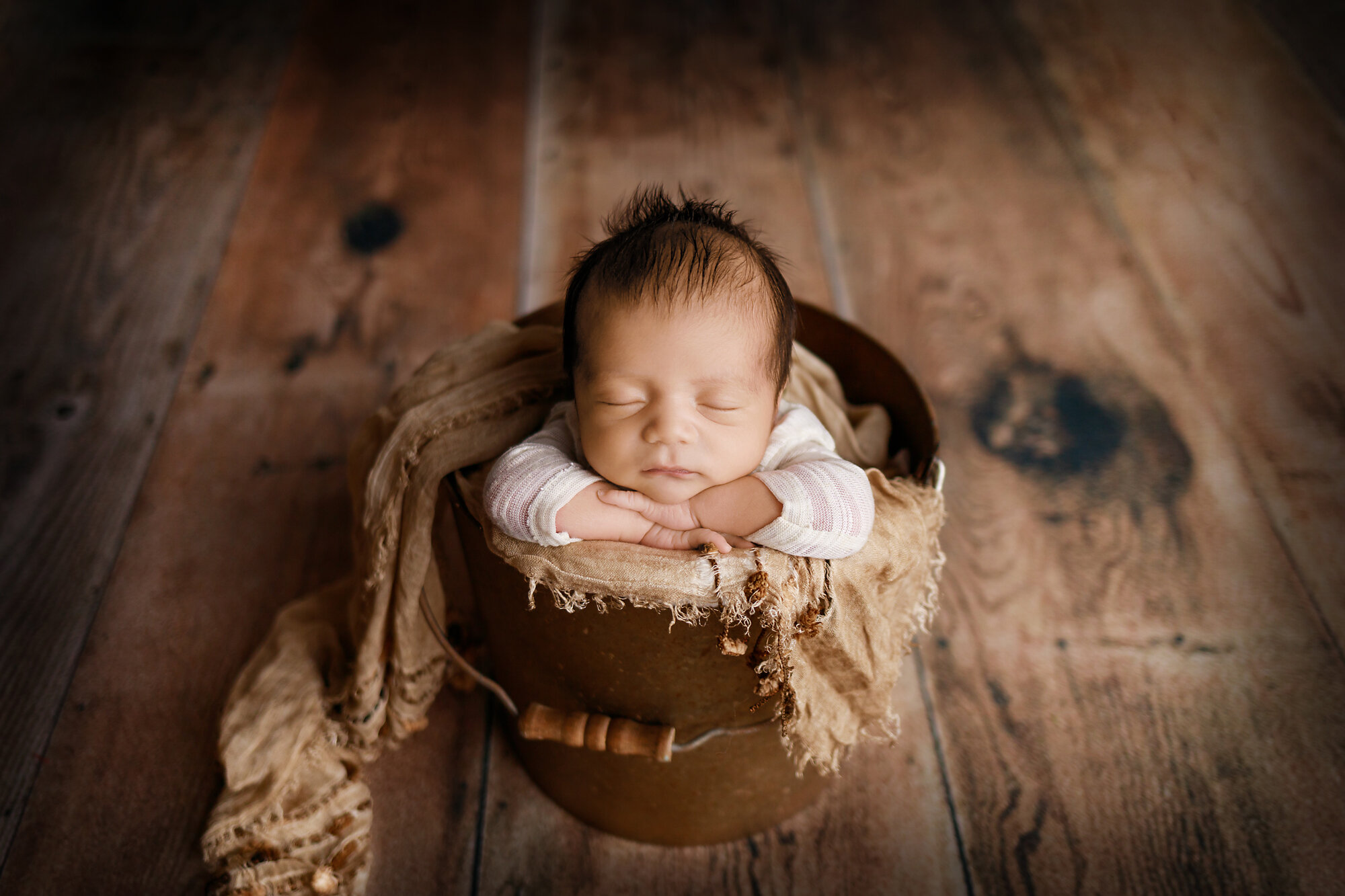 newborn boy in bucket pose