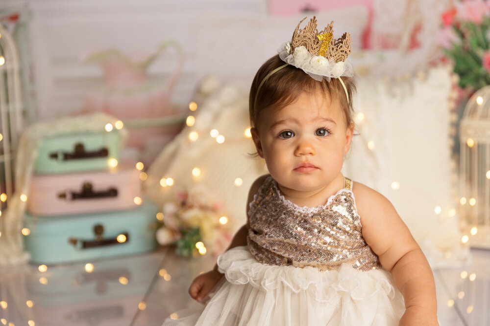 baby girl princess cakesmash with bokeh lights