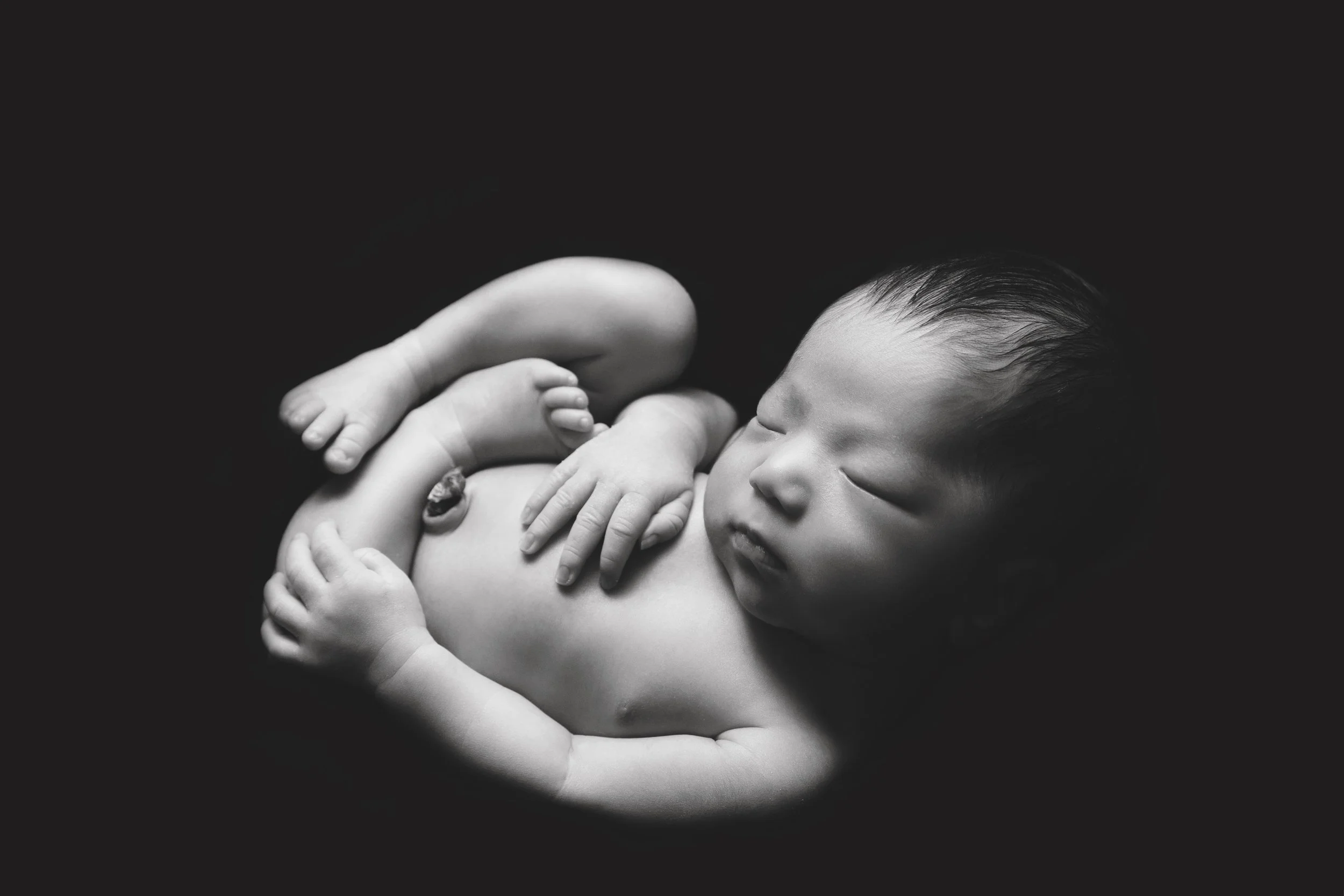 newborn-huck-finn-pose-black-and-white.jpg