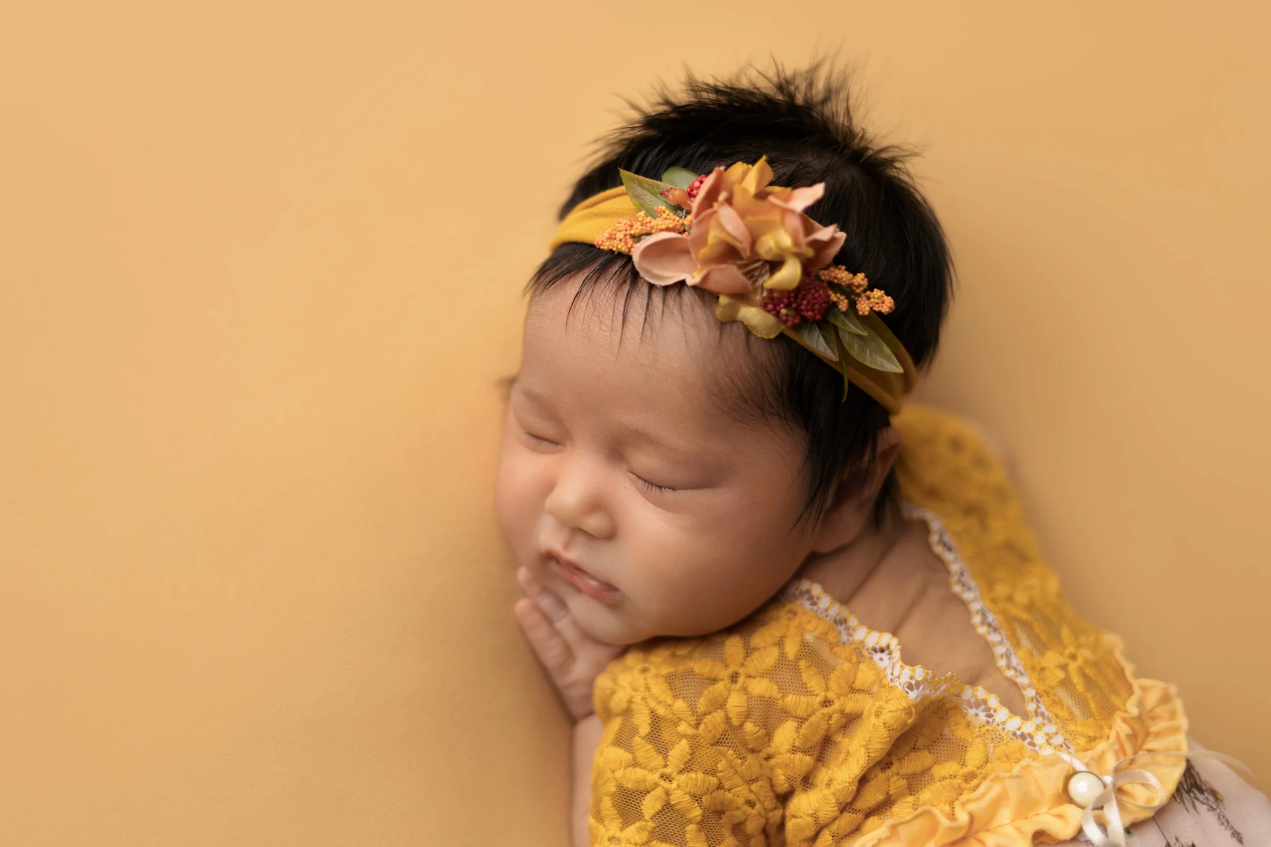 newborn-bum-up-pose-yellow-outfit.jpg