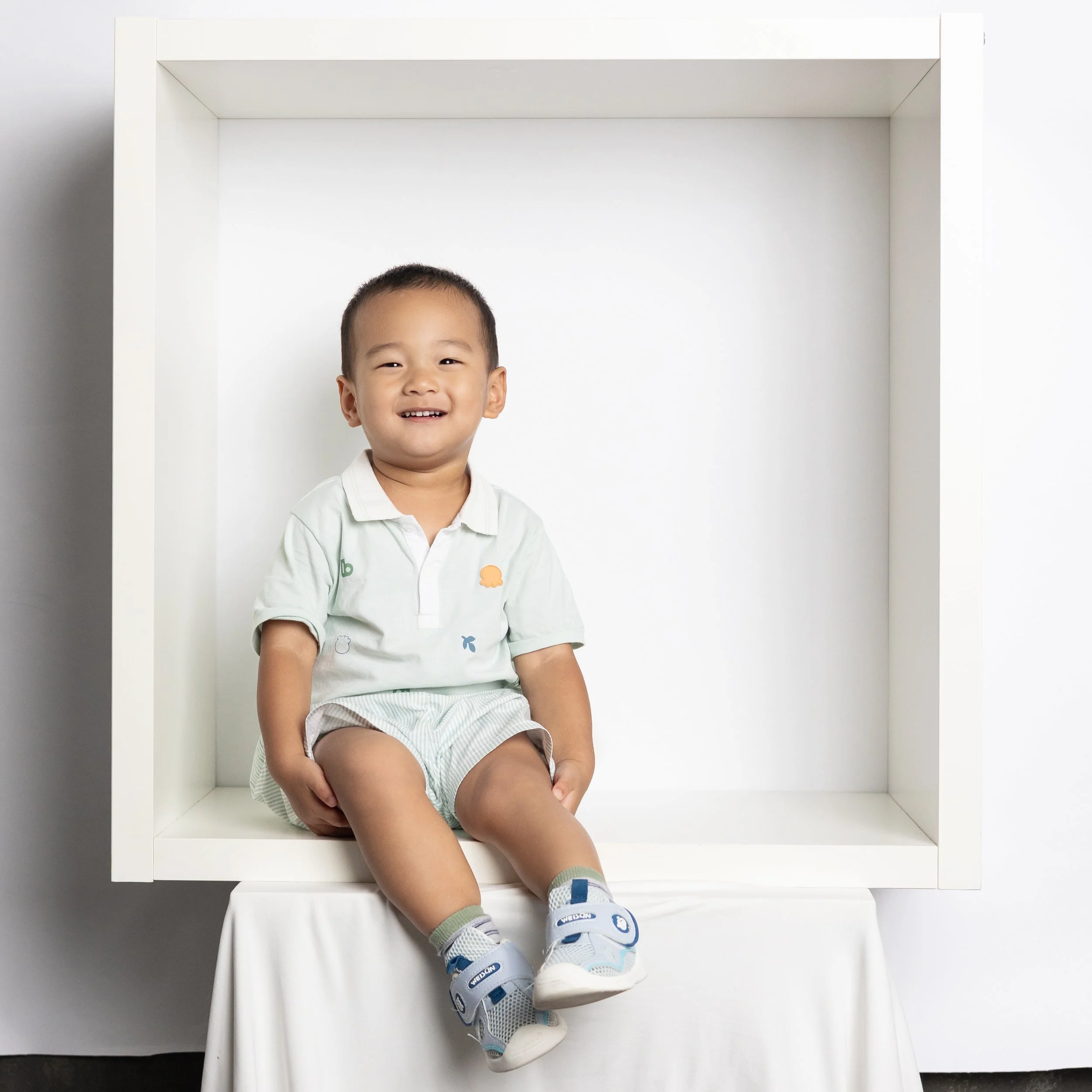  Toddler boy sitting in box for photography mini session in Austin Texas studio 
