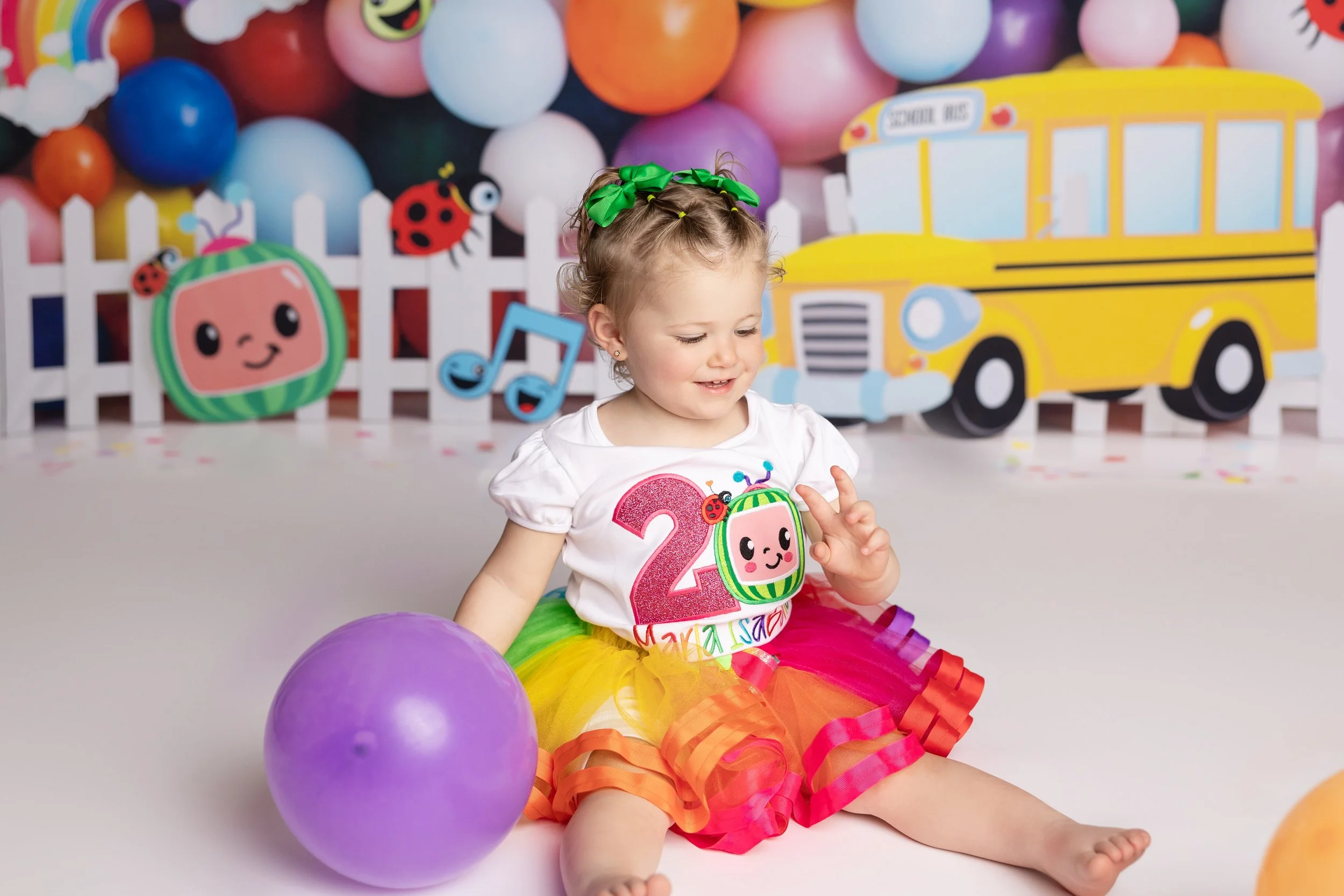 cocomelon themed toddler birthday photoshoot colorful setup