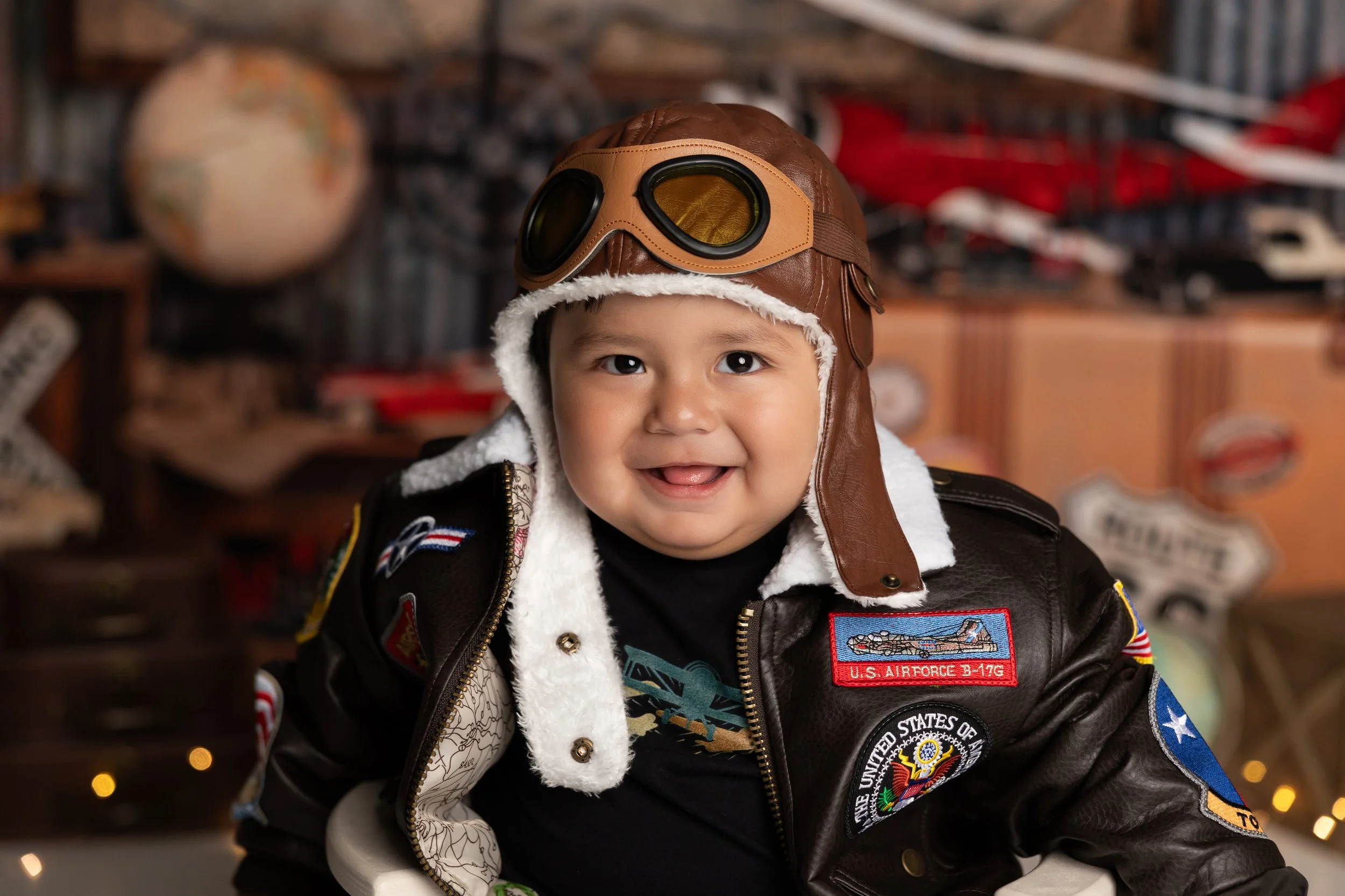 Travel cake smash theme – first birthday boy portrait in pilot outfit
