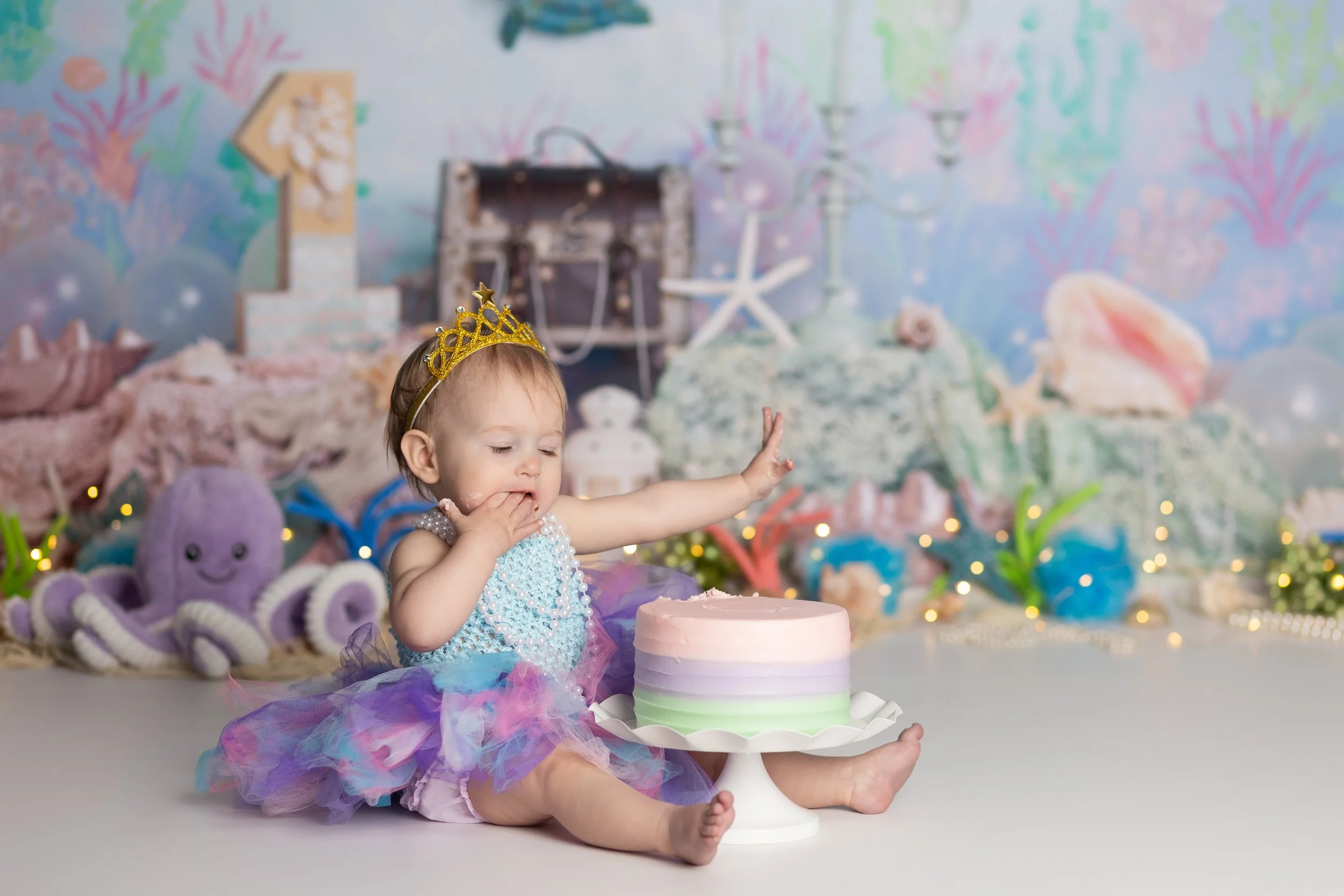 Mermaid cake smash – first birthday girl with pastel cake and under the sea theme