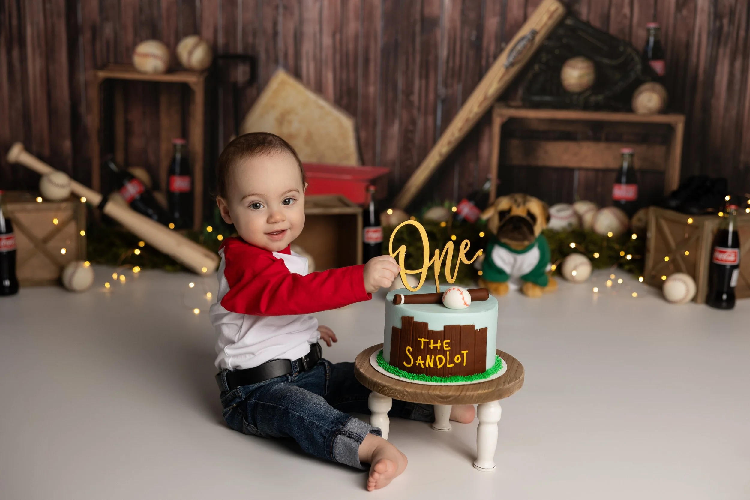 Sandlot cake smash – first birthday boy with baseball themed cake