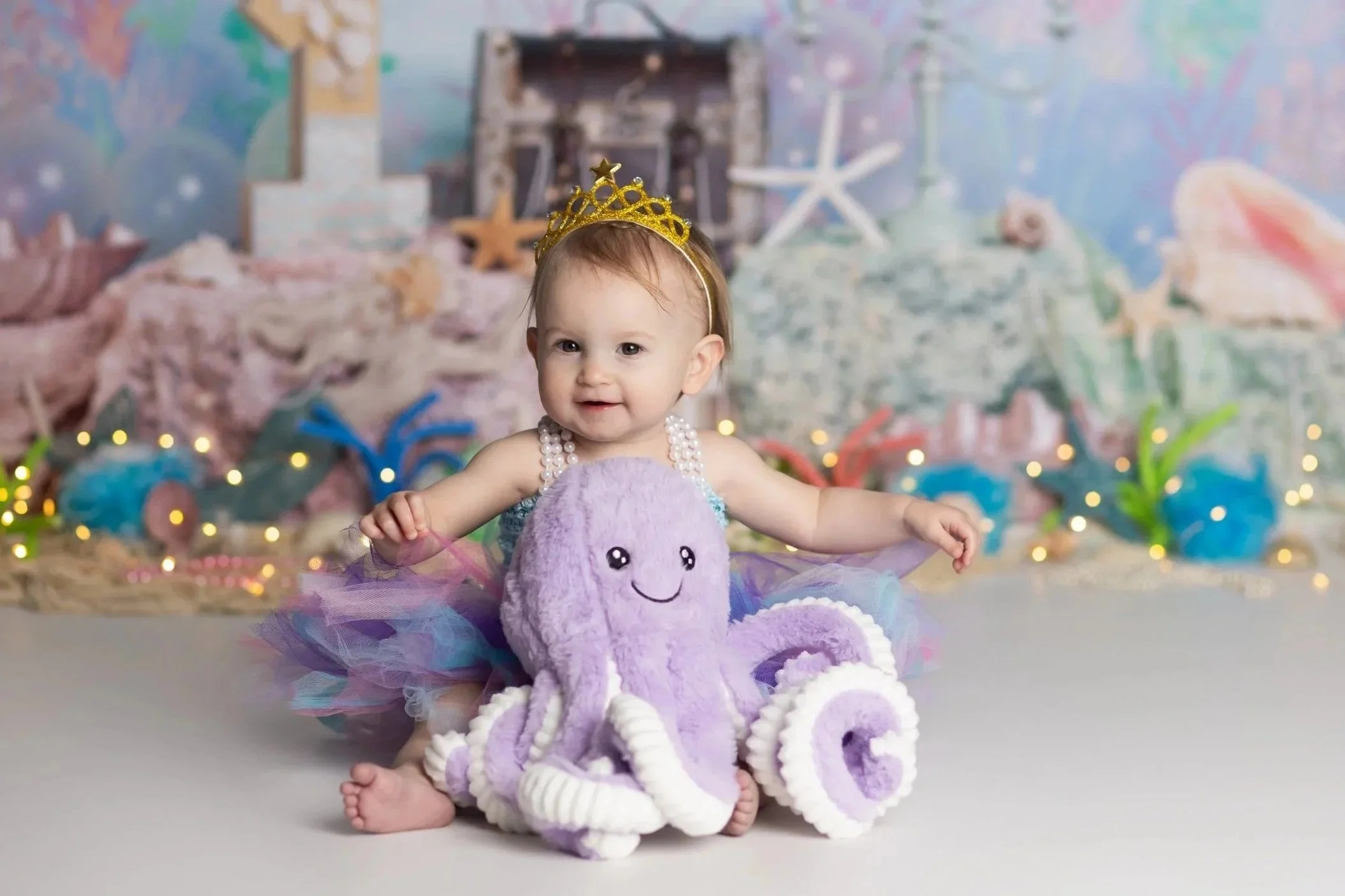 Mermaid cake smash theme – first birthday girl portrait with ocean-inspired setup