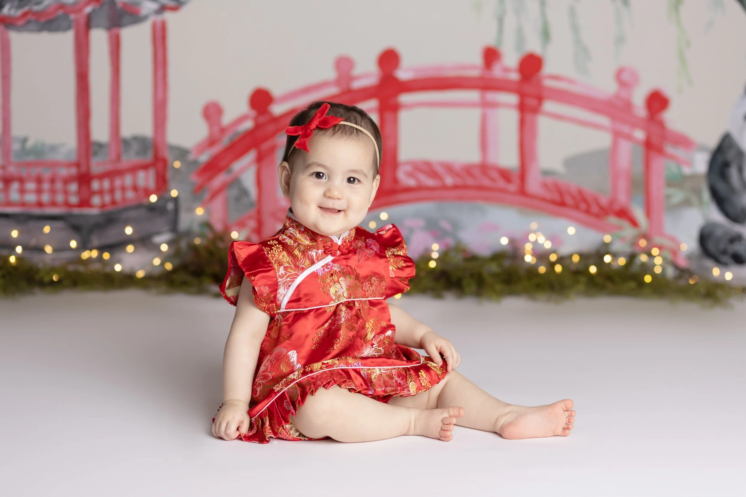 Chinese-inspired cake smash theme – first birthday girl portrait in traditional outfit