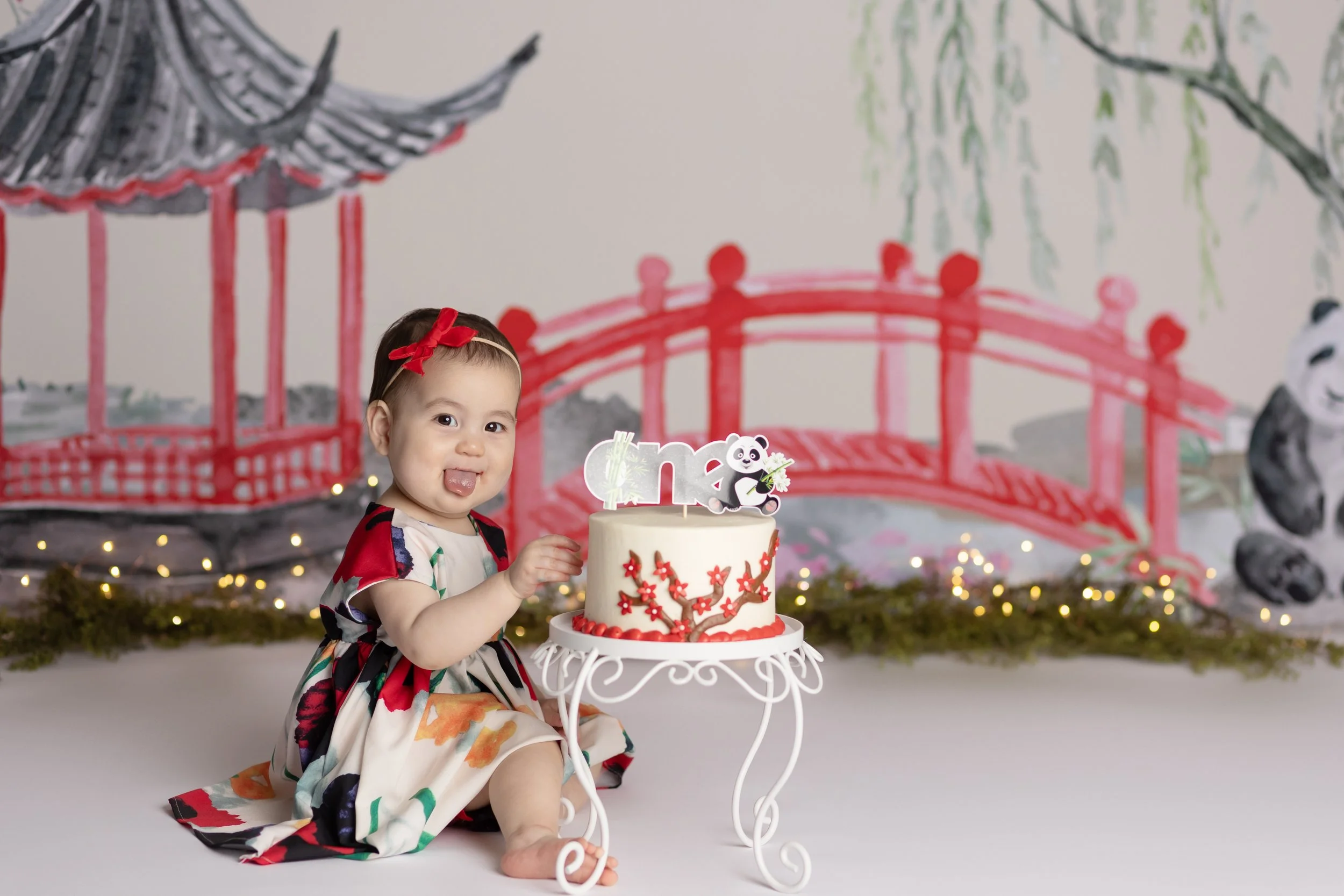 Chinese-inspired cake smash – first birthday girl with elegant themed cake