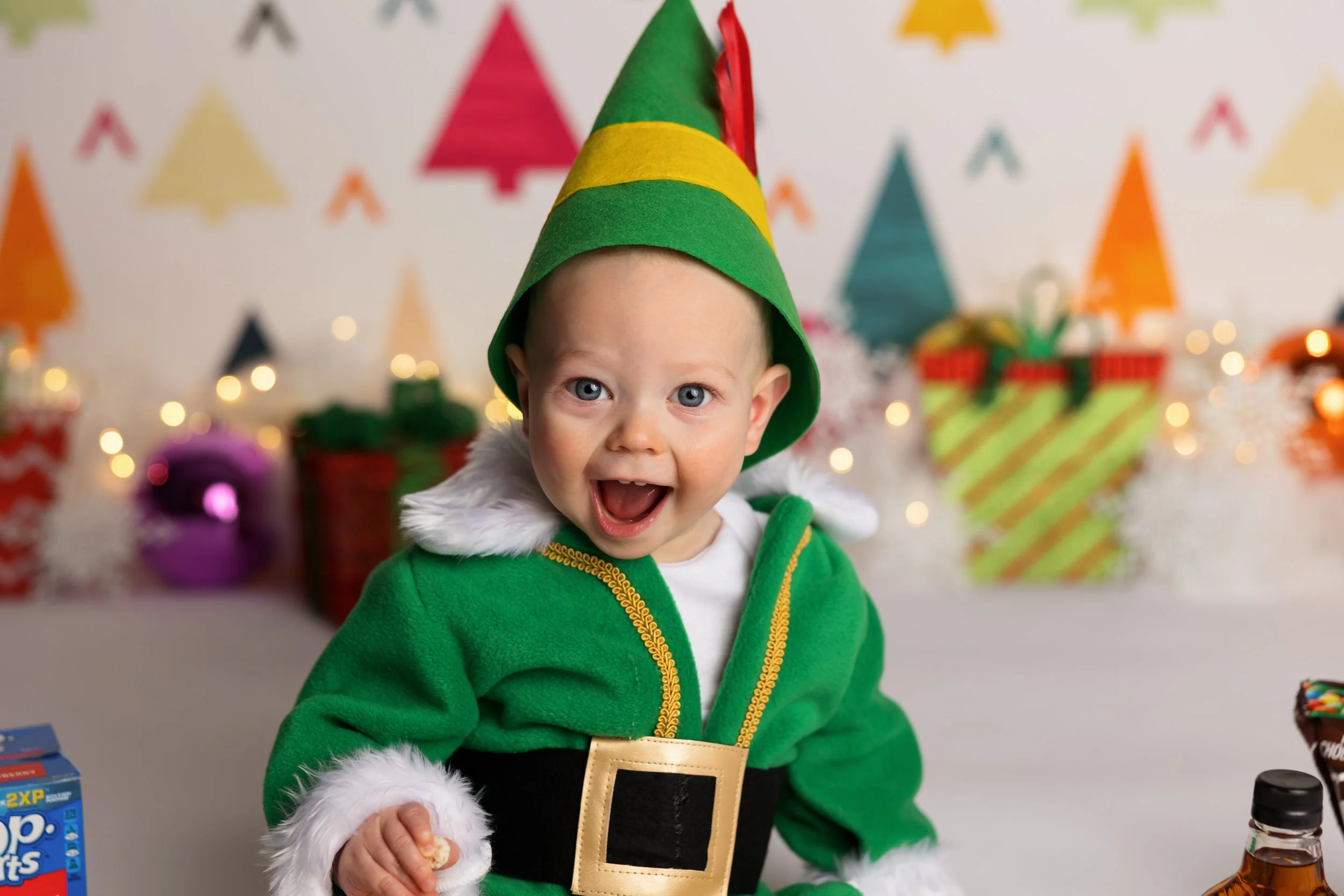 Buddy the Elf cake smash theme – first birthday boy smiling in holiday outfit