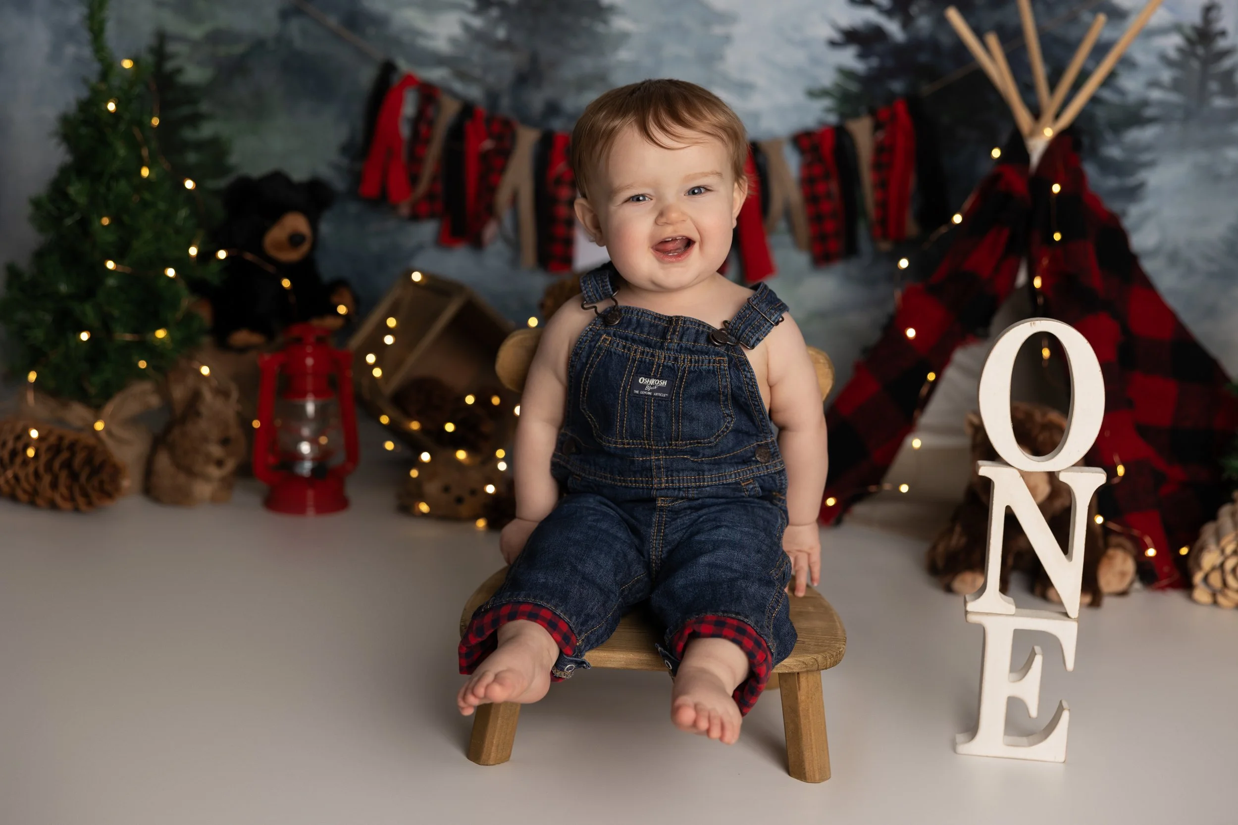 One Happy Camper cake smash theme – first birthday boy portrait with outdoor setup