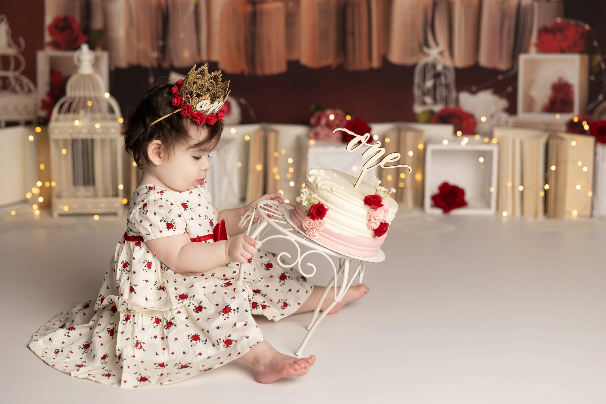 Floral books cake smash – first birthday girl with floral cake and storybook theme
