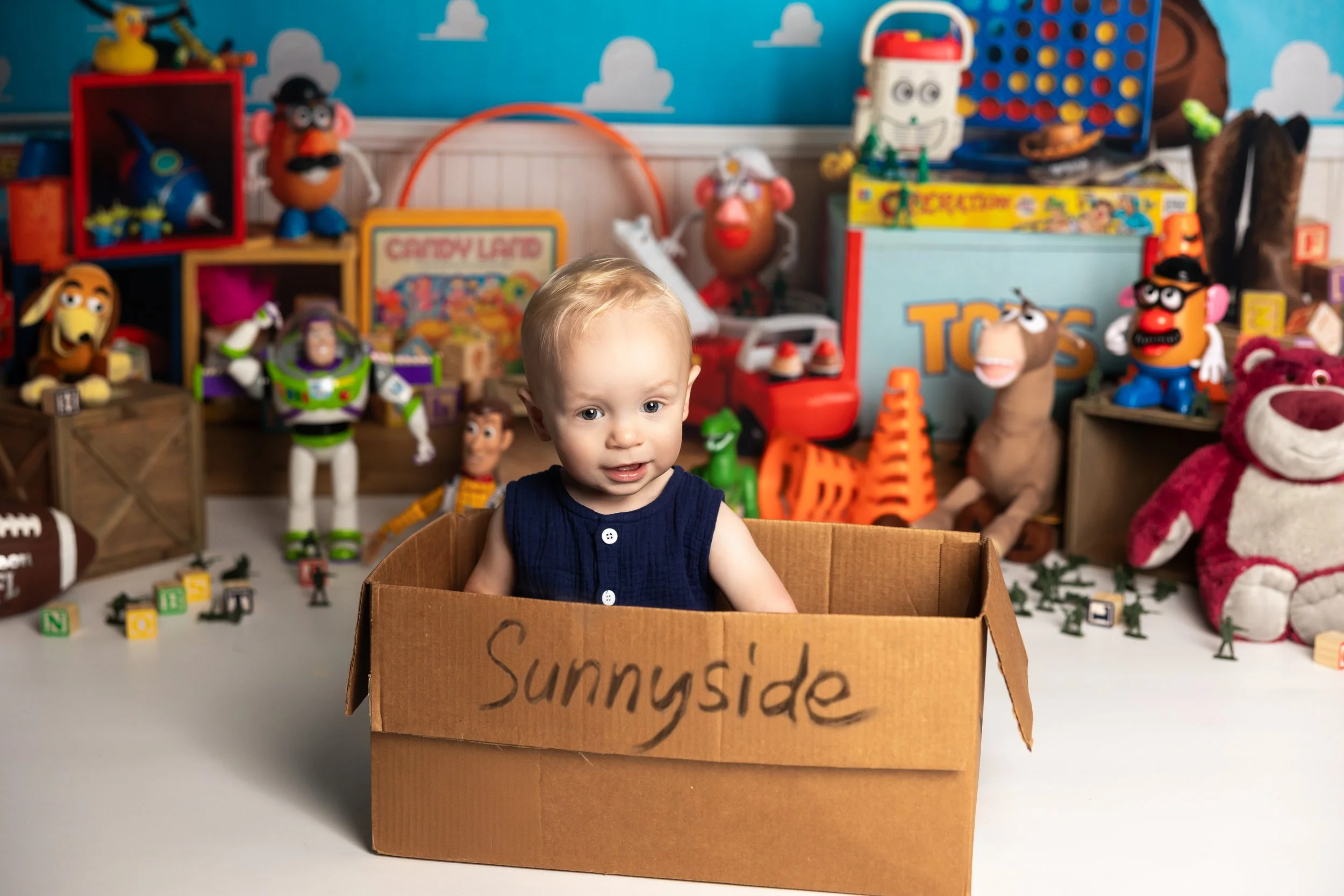 Toy Story cake smash theme – first birthday boy portrait with themed setup