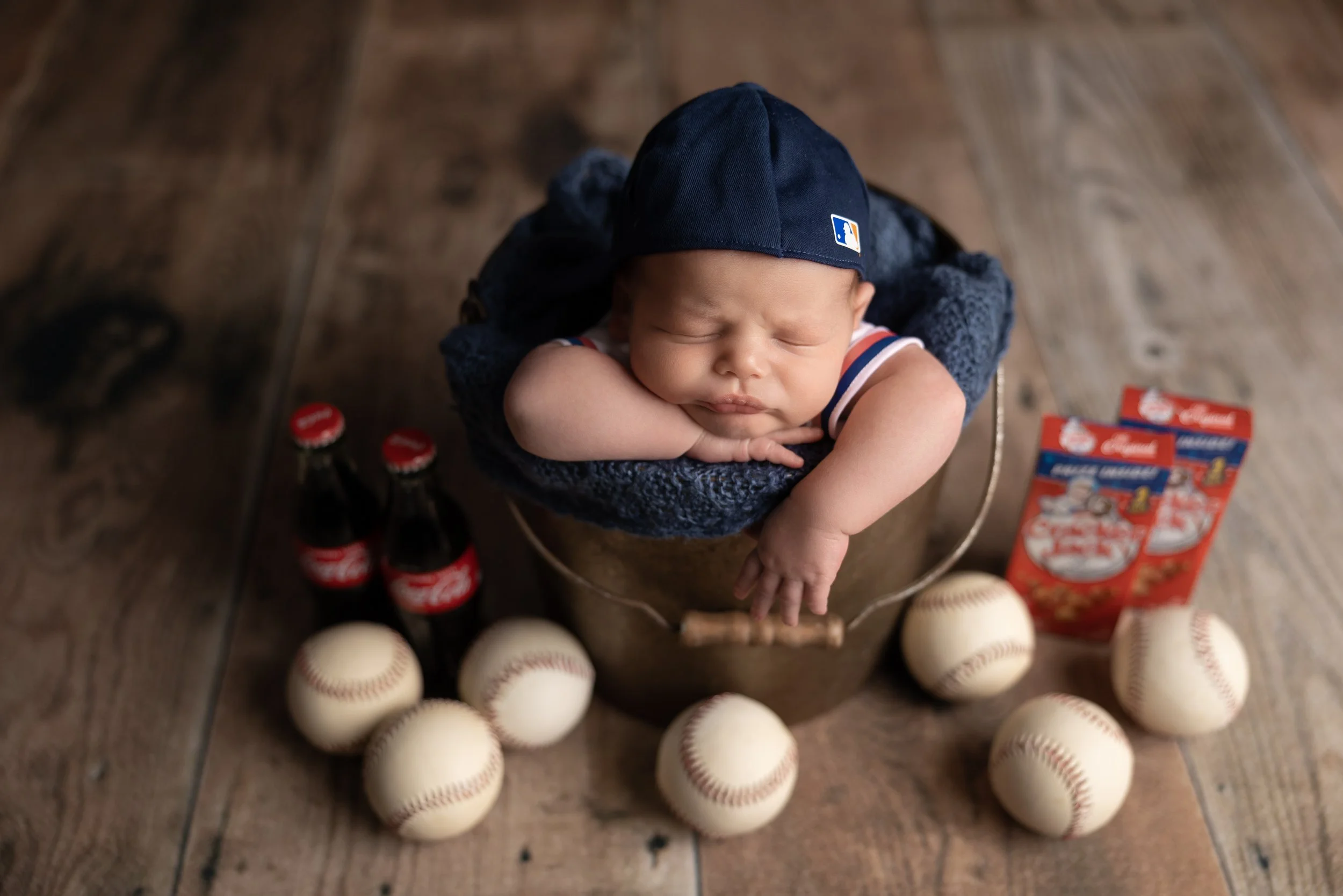 Newborn baseball theme with bat and bucket setup