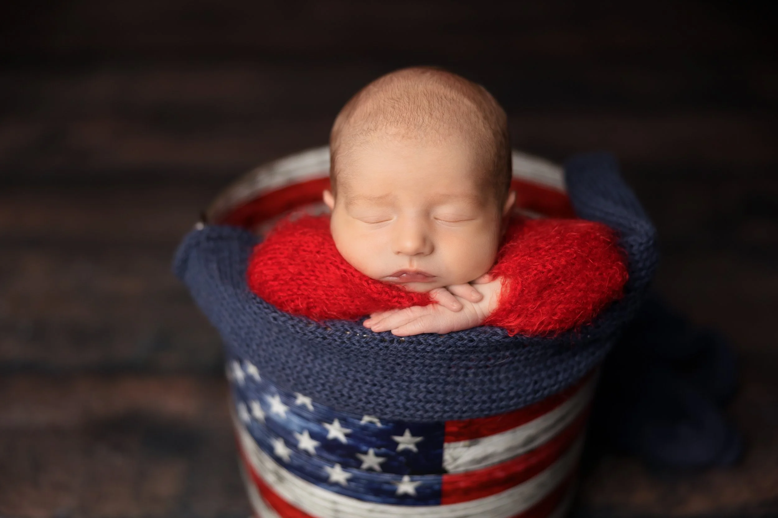 Newborn in red white and blue bucket patriotic setup