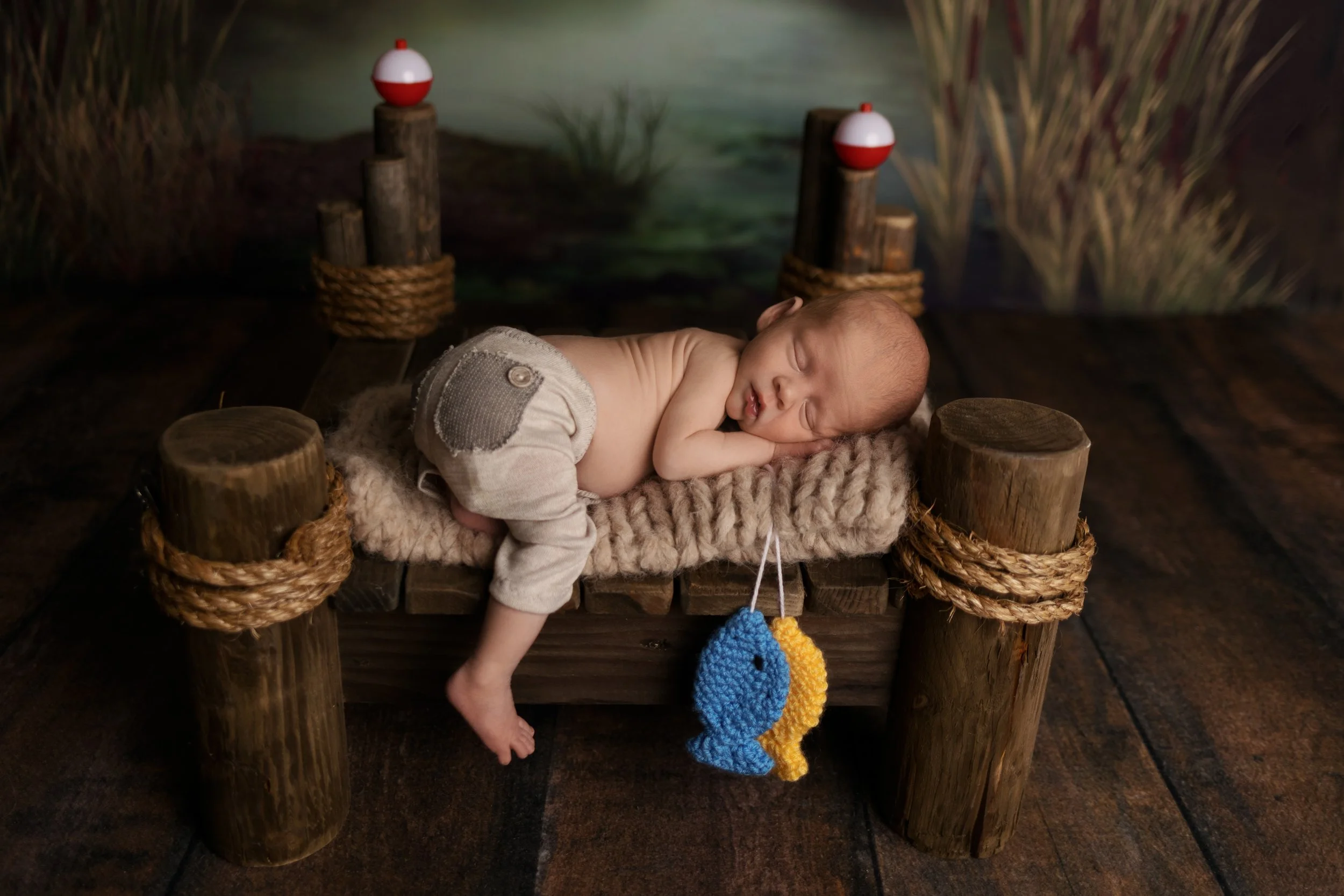 Newborn fishing theme with dock and bobbers setup