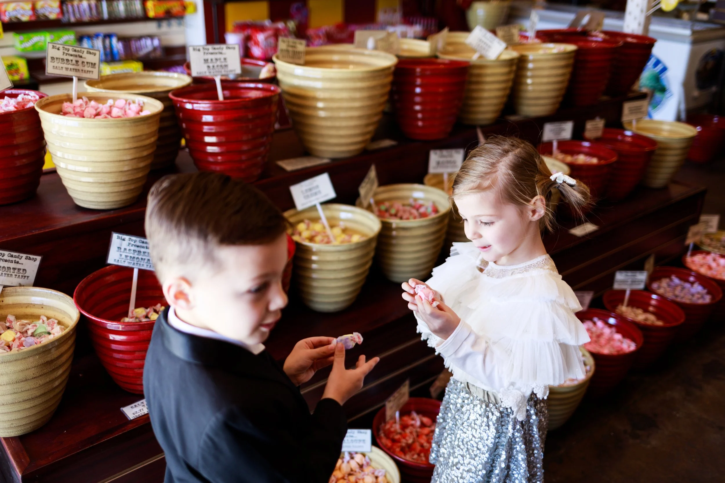 Kids choosing candy from bowls
