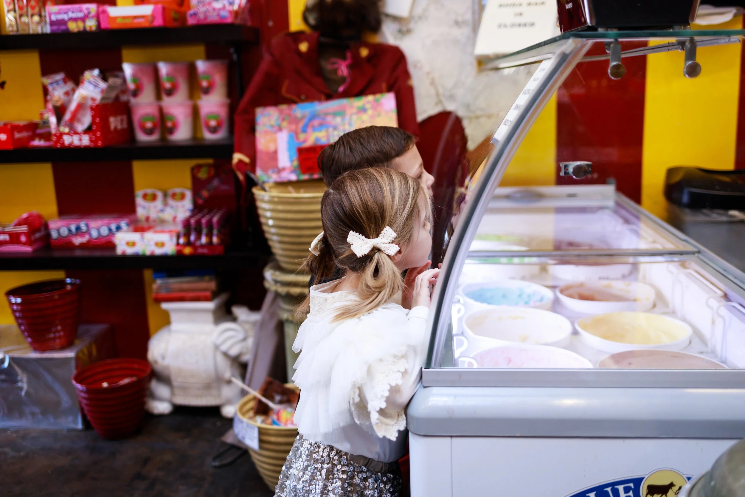 Little girl looking into ice cream case