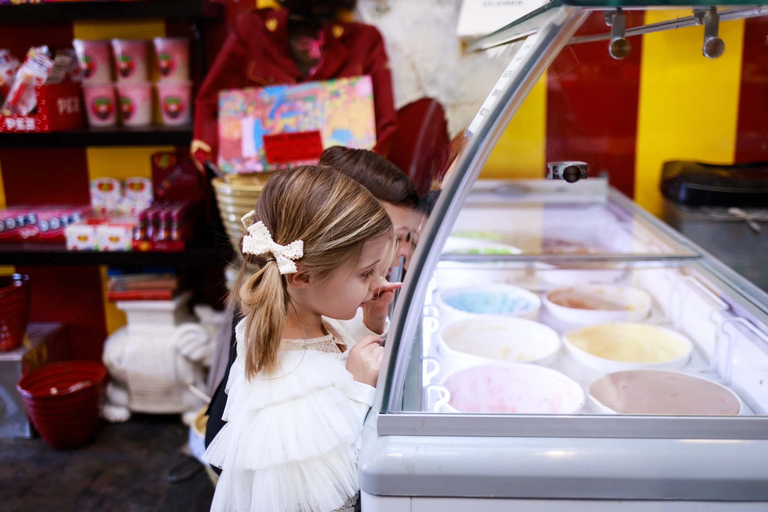 Child peeking into ice cream display