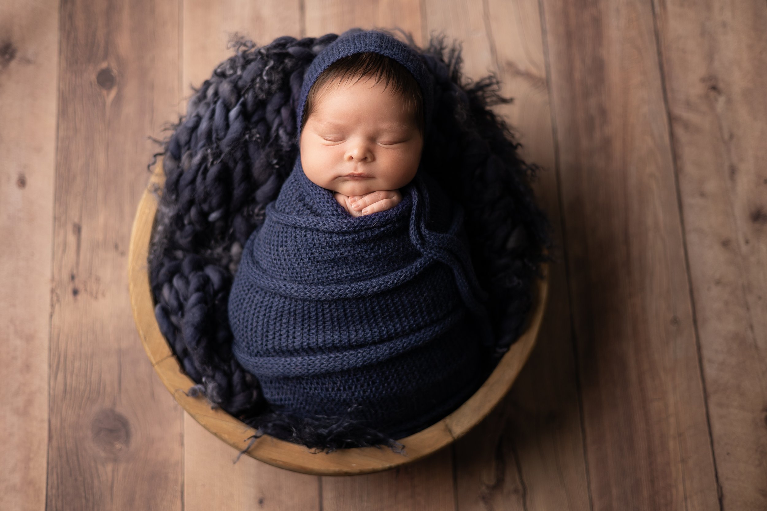 Newborn Boy Wearing a Bonnet Portrait