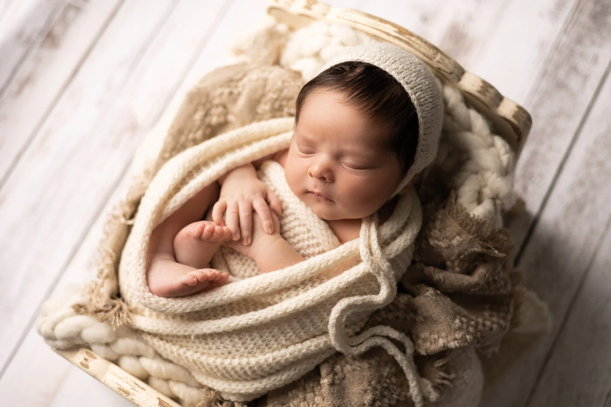Newborn Boy Swaddled in Cream Textures