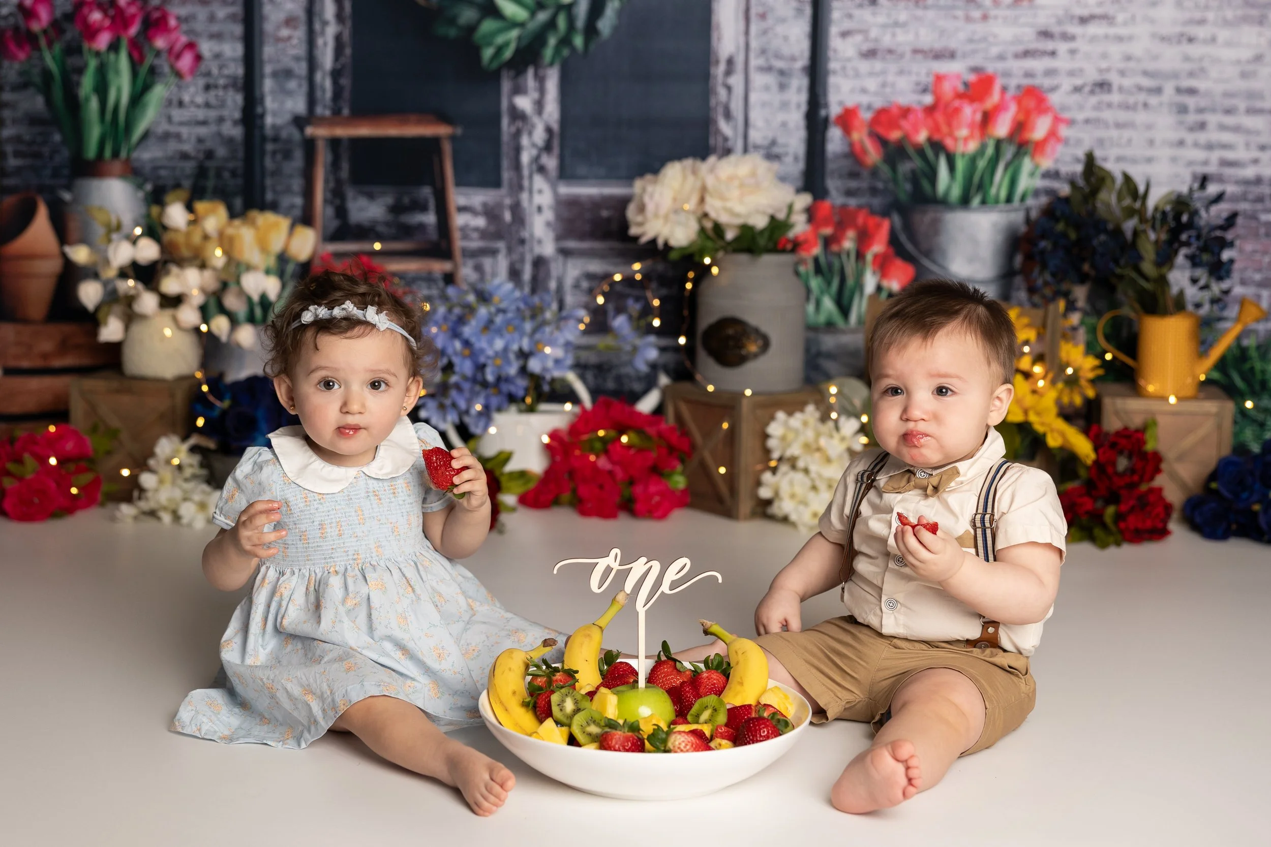 Twin Babies Playing With Fruit During Milestone Session