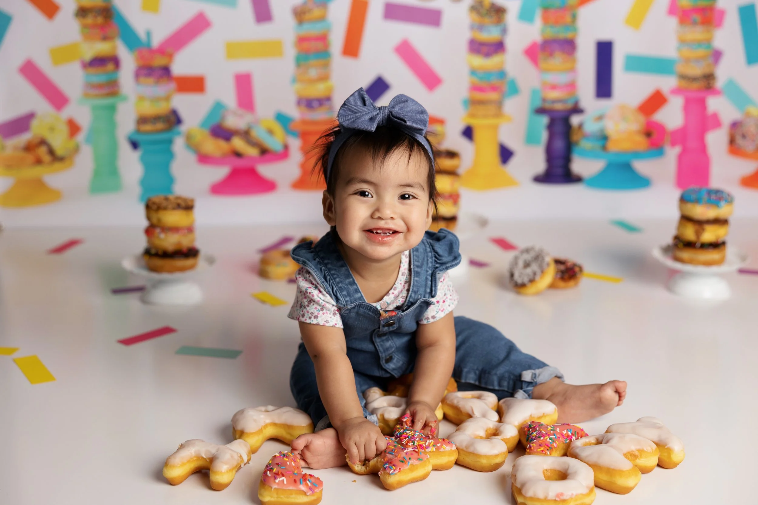 Baby Girl Sitting With Letter-Shaped Donuts