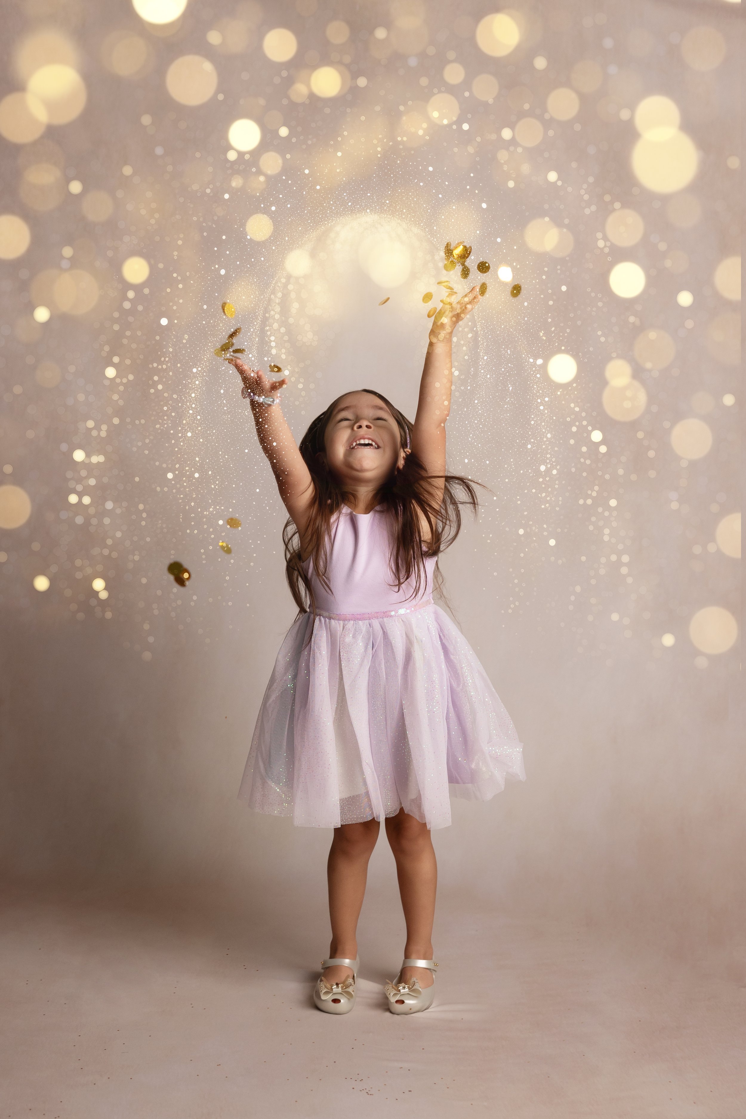 Child Tossing Glitter Confetti in Studio Portrait