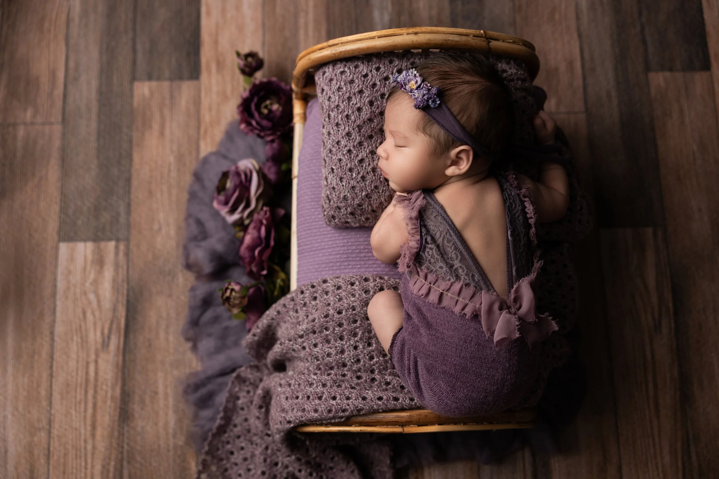 Overhead Newborn Bed Portrait in Plum Tones