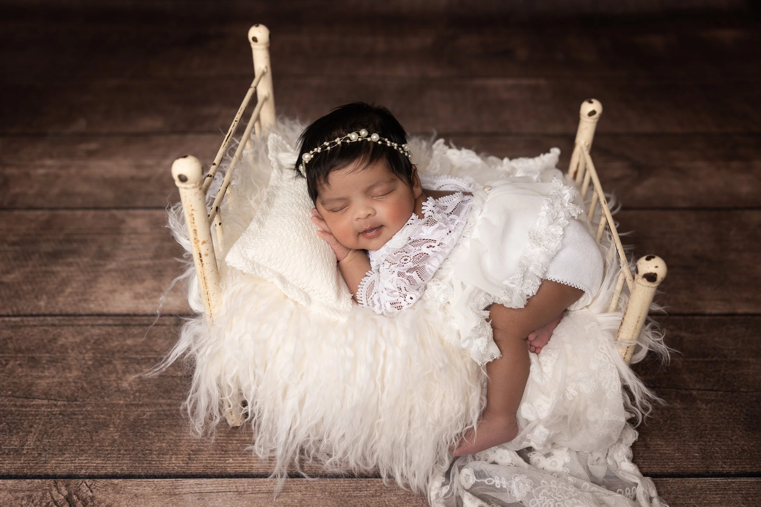 Elegant Newborn Bed Portrait in White