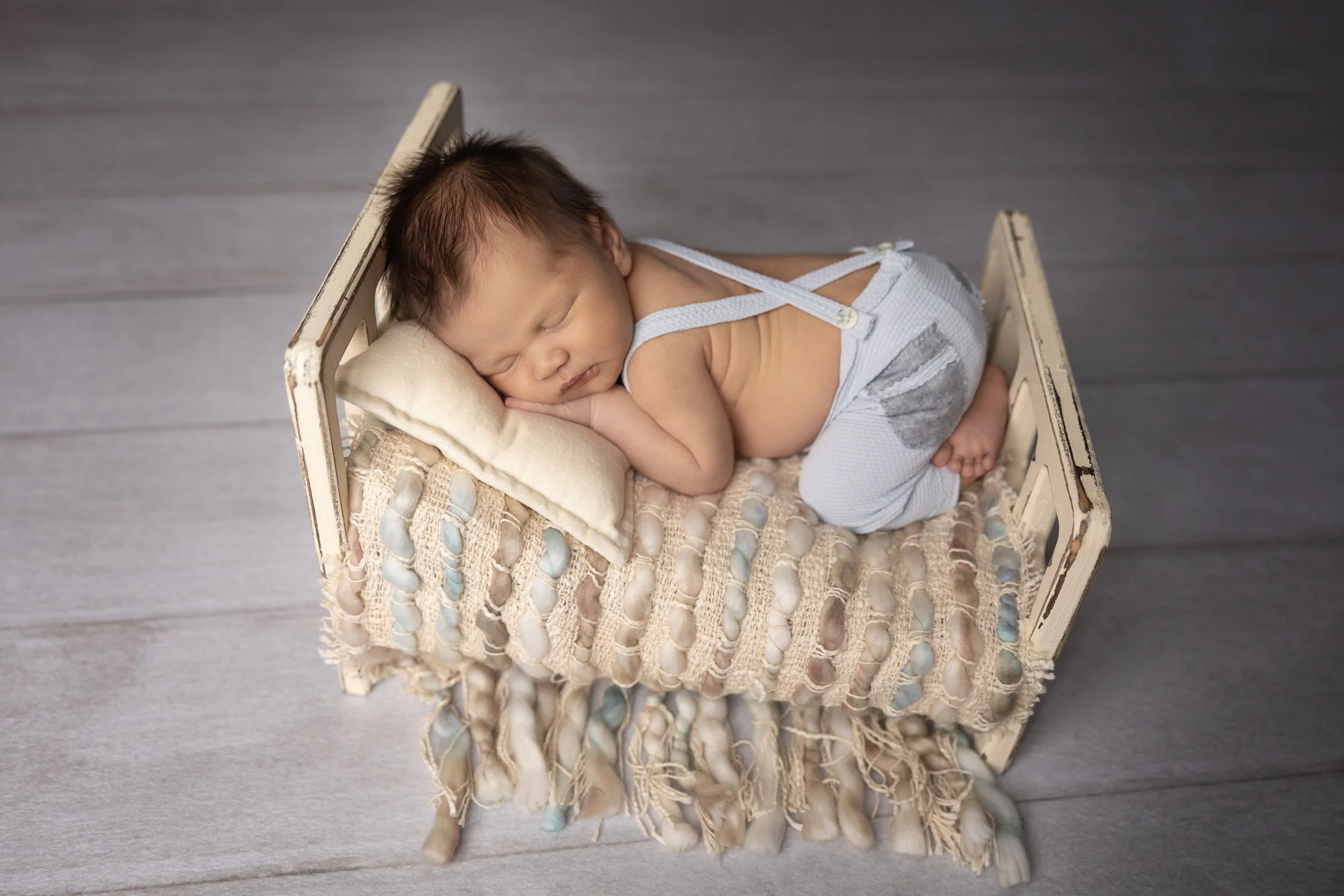 Blue Suspender Newborn Bed Portrait