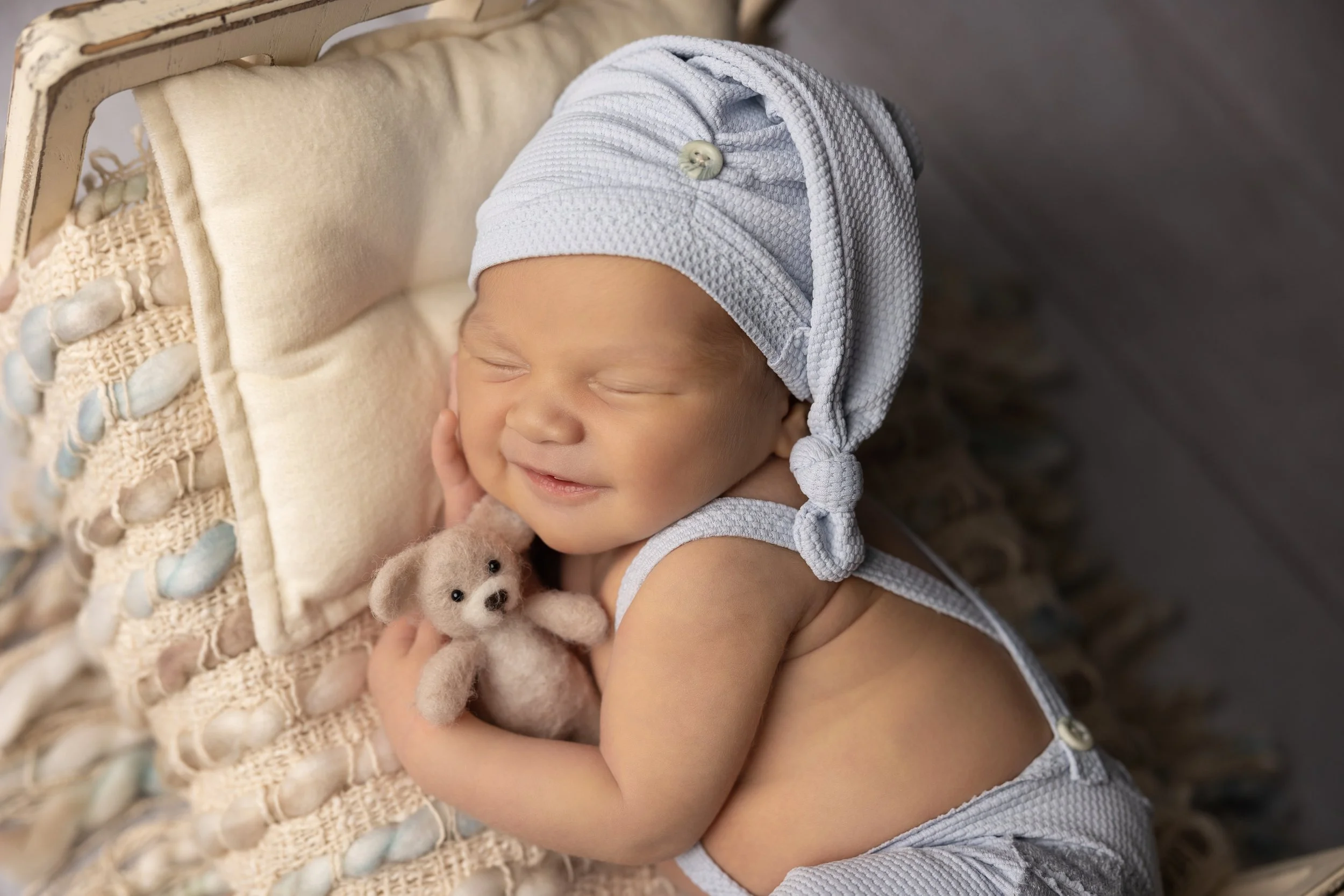 Smiling Newborn Portrait with Teddy Bear