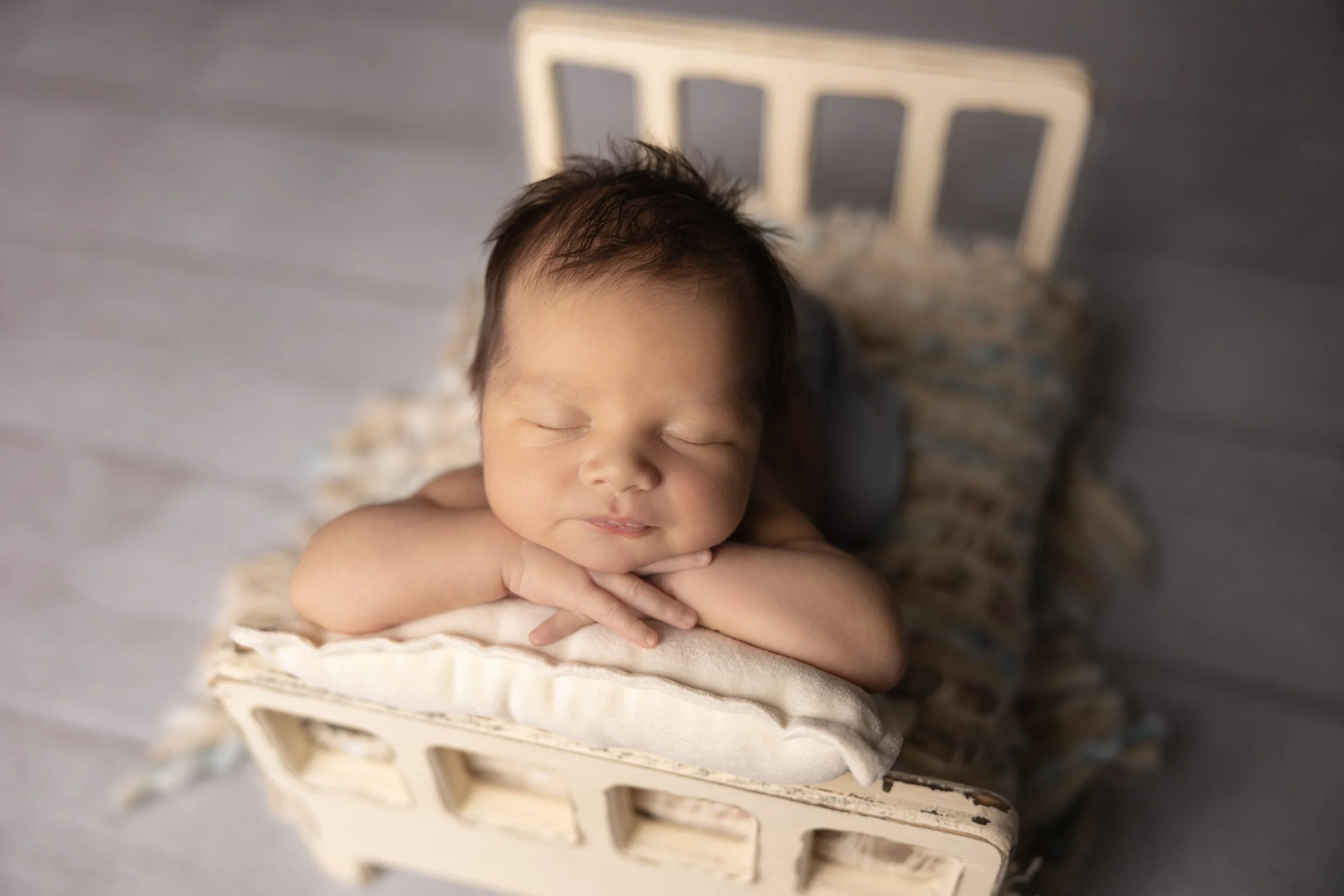 Classic Chin-on-Hands Portrait in Vintage Bed