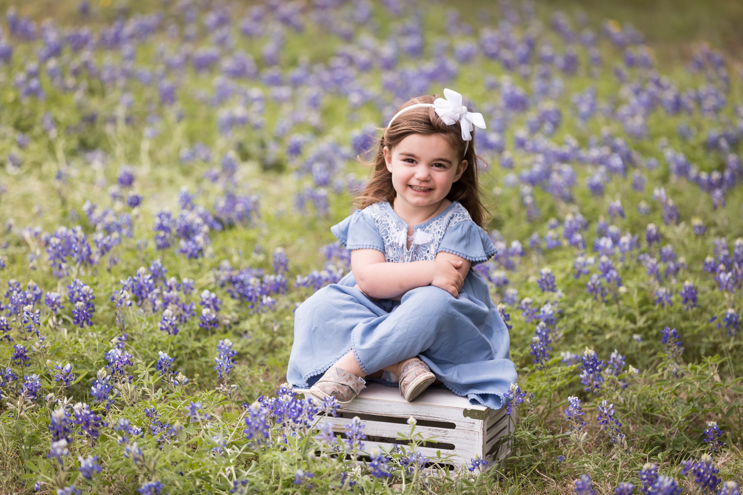 Little Girl Sitting Among Bluebonnets