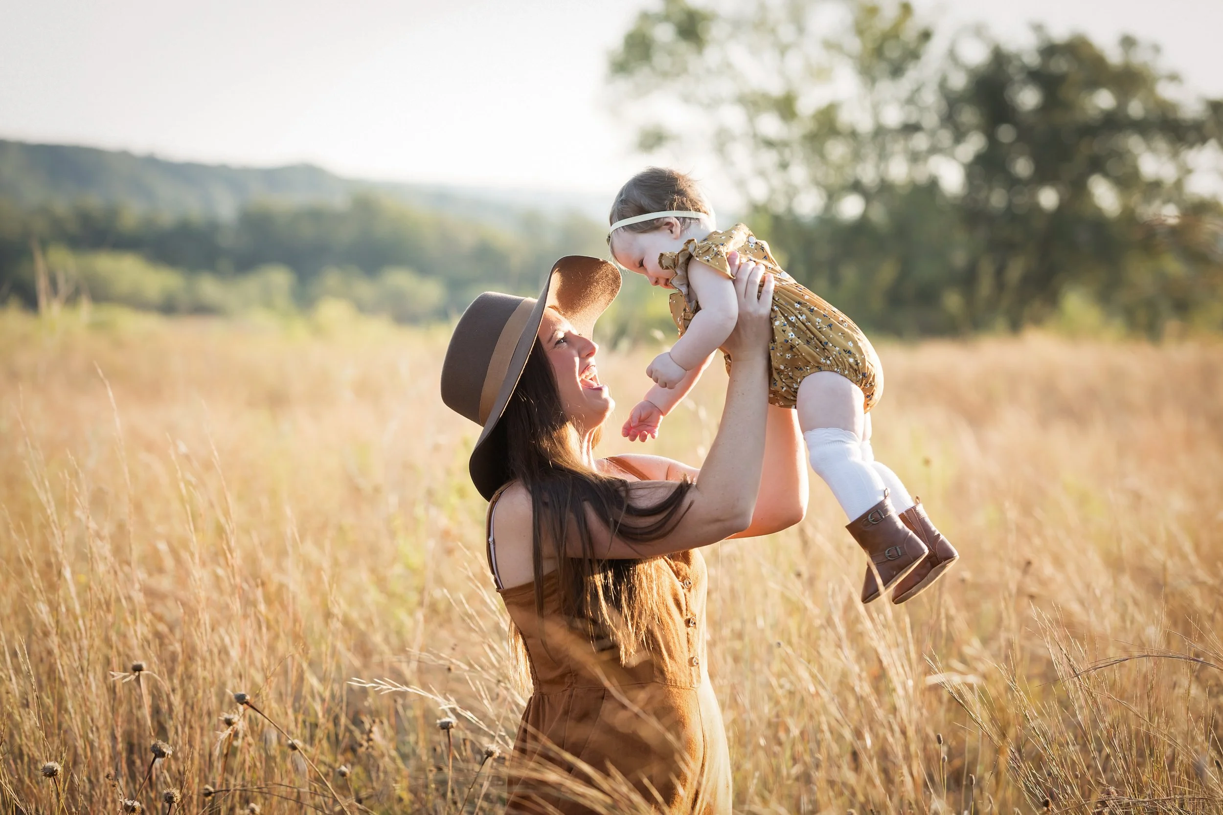 mom-lifting-baby-in-golden-field-austin-family-photographer.jpg
