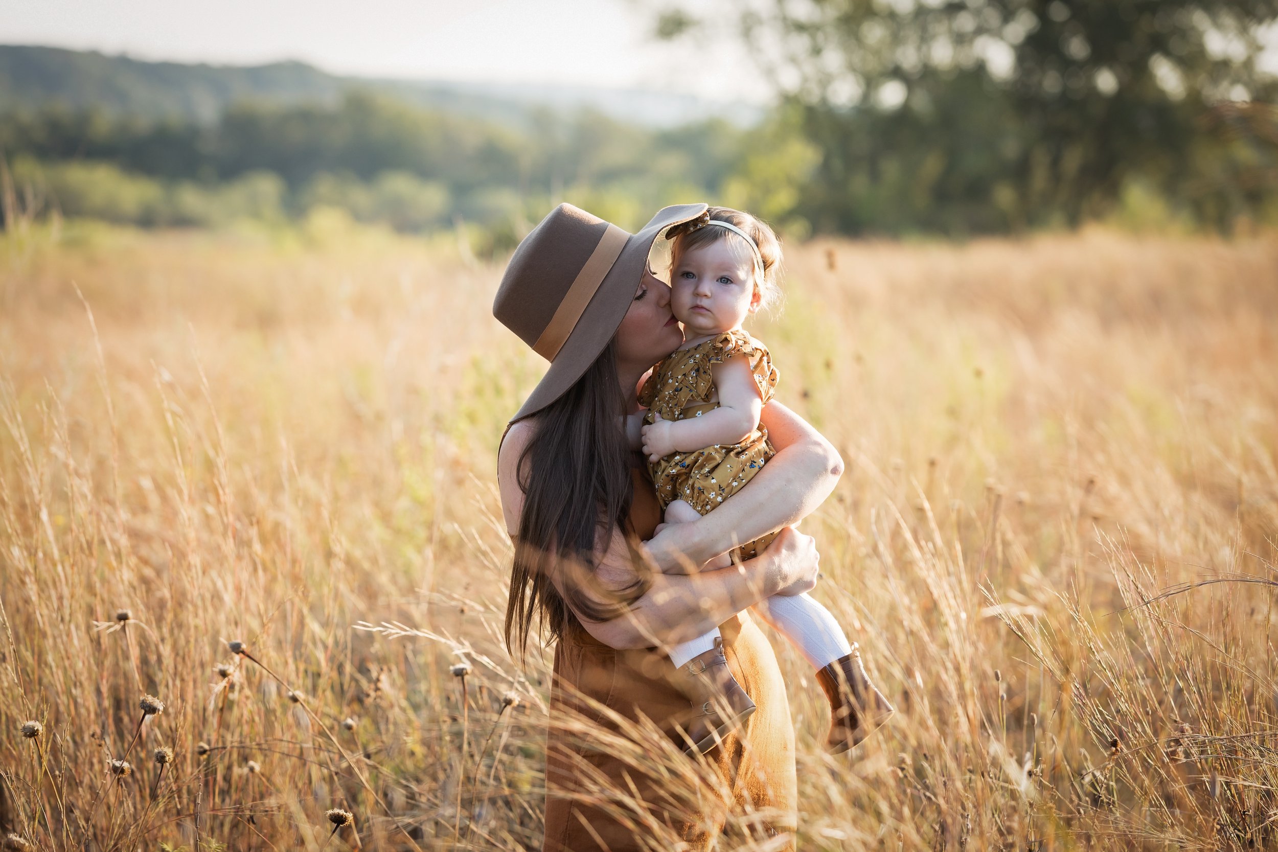 mother-holding-baby-in-fall-field-austin-family-session.jpg