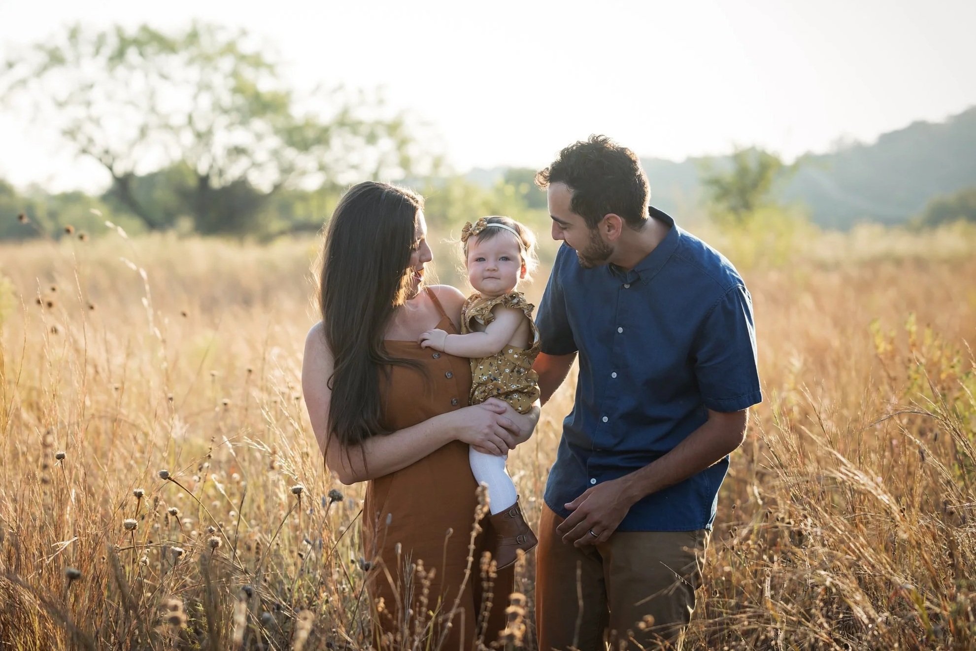 family-walking-through-golden-field-commons-ford-ranch-austin.jpg